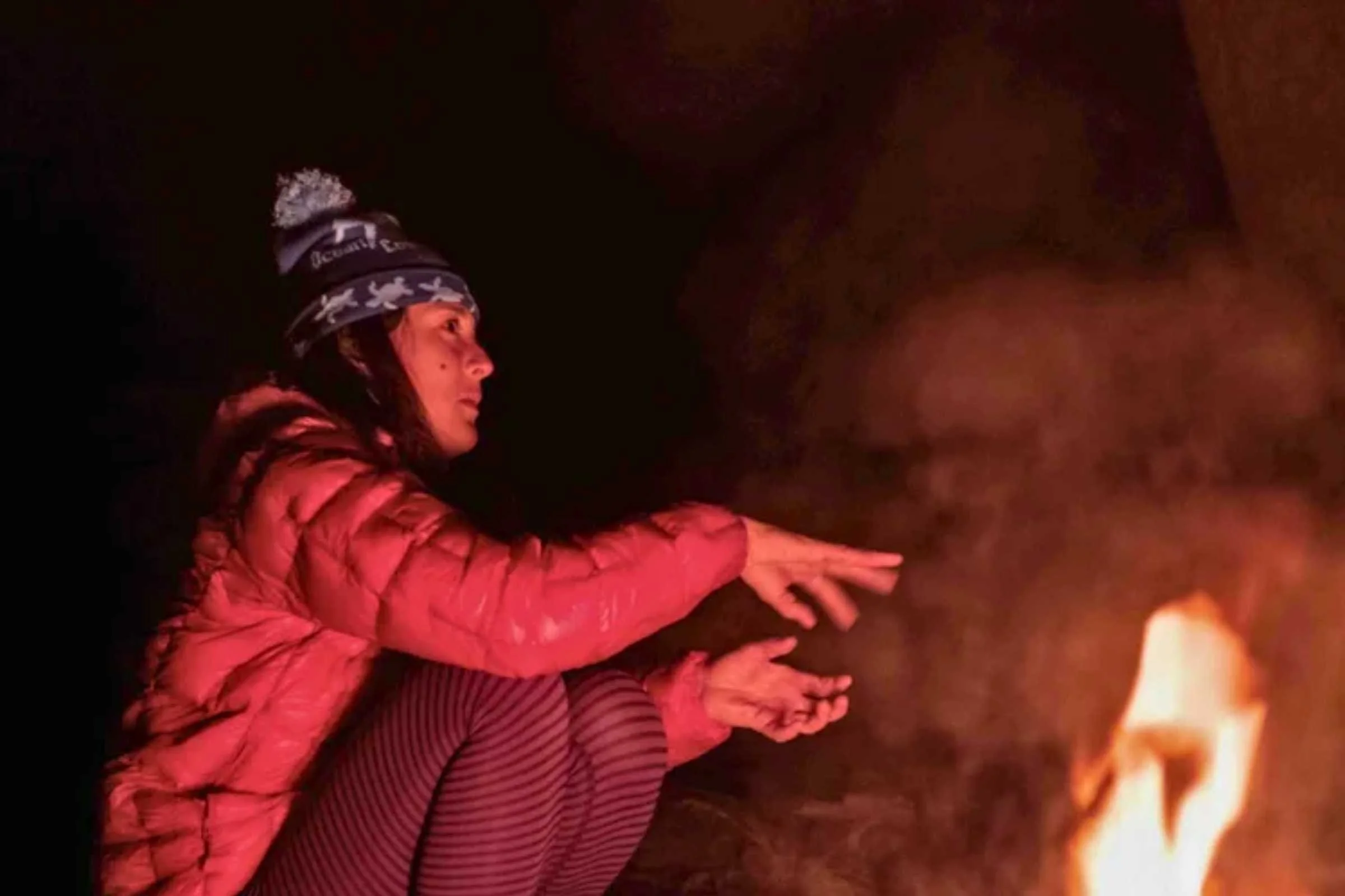 Treeline Editor Liz Thomas telling a campfire story in the Montbell Plasma on a trip in late fall in the Emigrant Wilderness in the Sierra Nevada. Photo by Duncan Cheung.