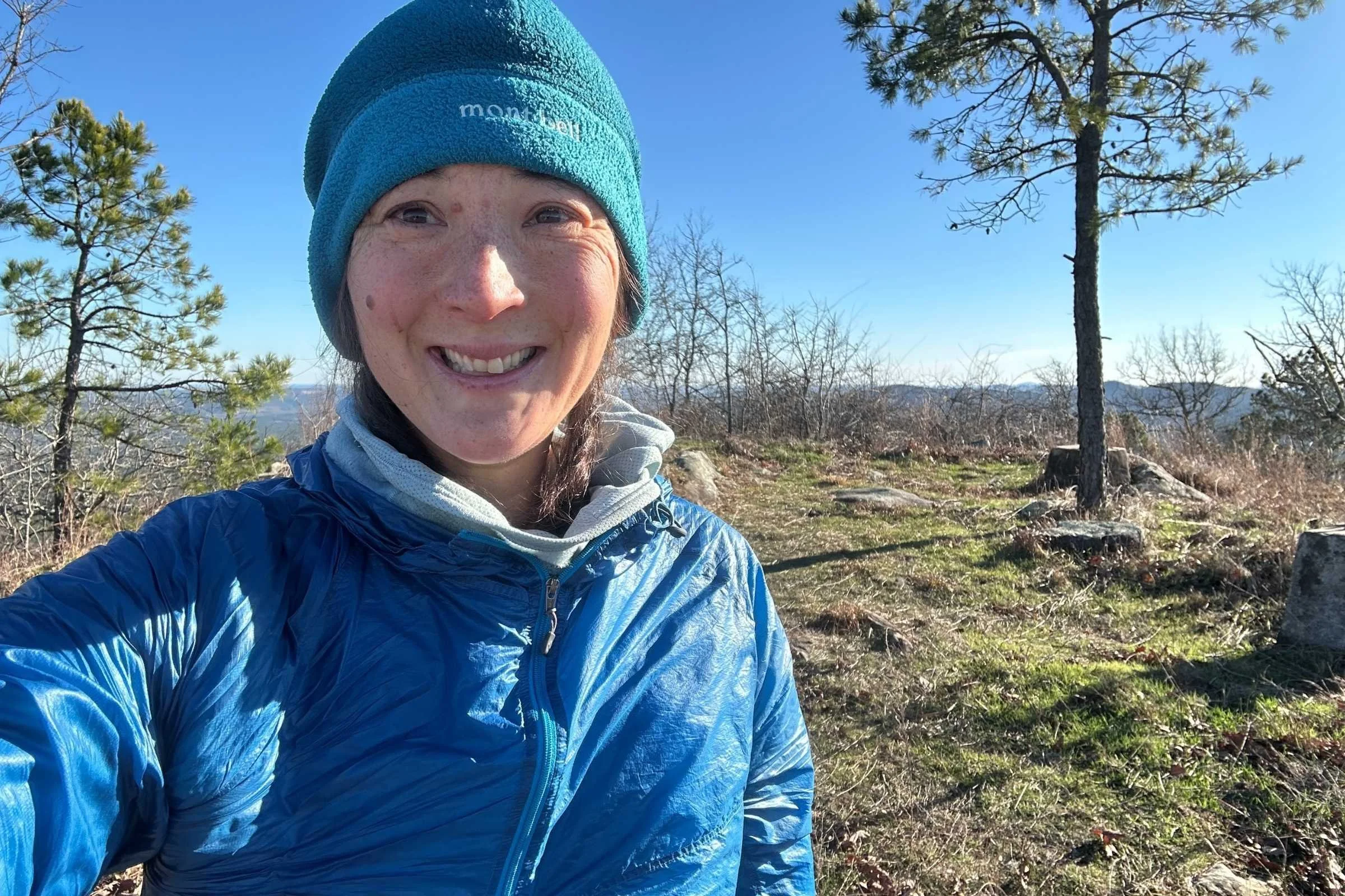 Liz took a side trip to climb the nearby North Fork Pinnacle mountain, a sidetrip from the Ouachita Trail, to see some sunshine, and get some cell service. She's wearing the Mountain Hardwear AirMesh hoody under a windshirt. 