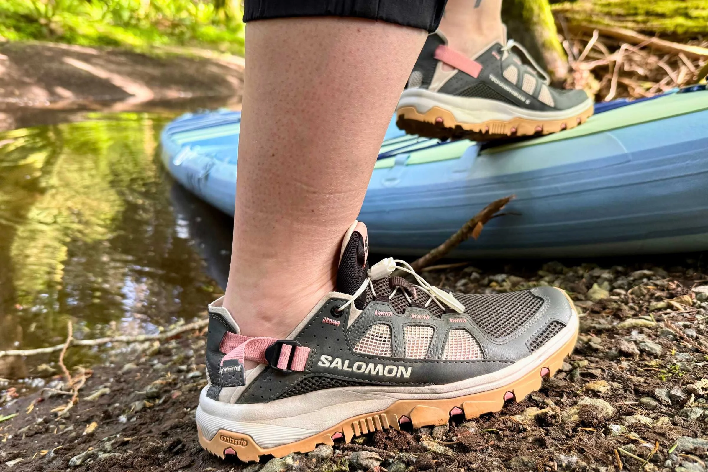 Stepping onto a SUP wearing the Salomon Techamphibian 5 water shoes