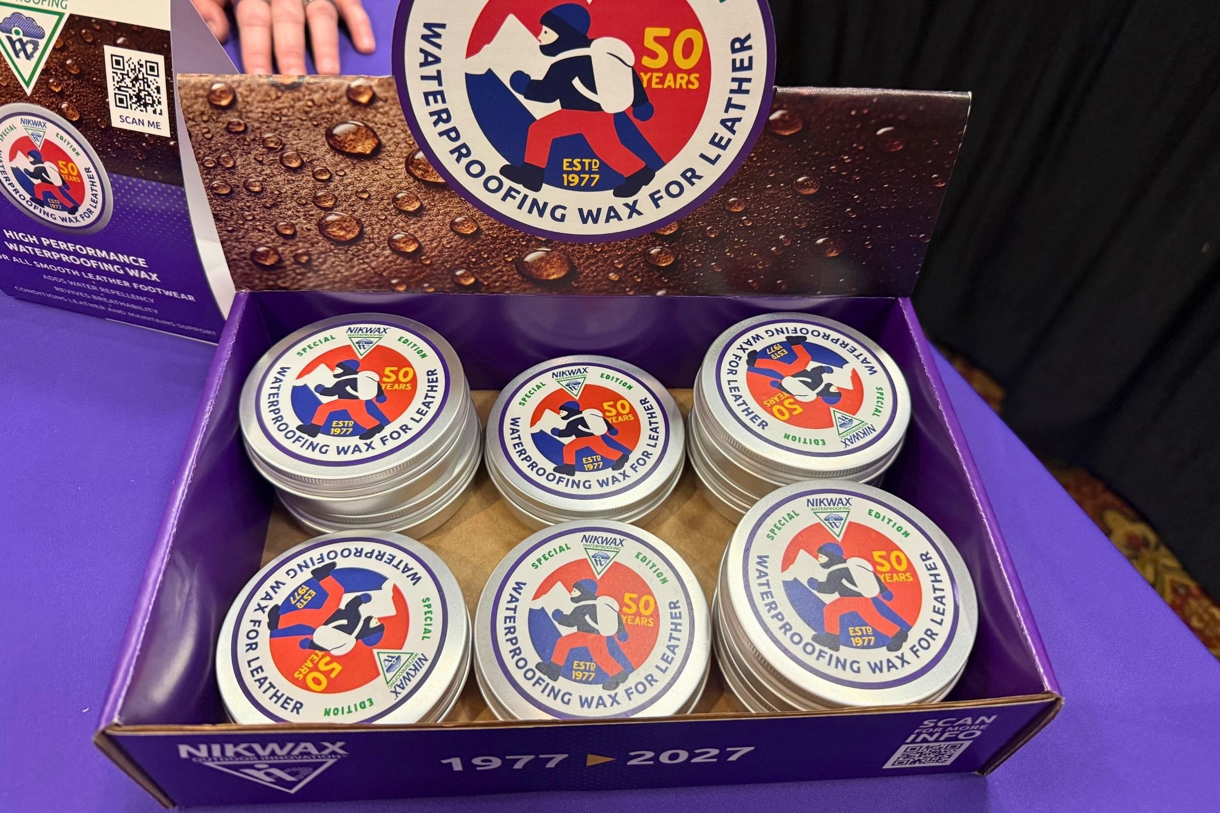 Box full of Nikwax 50th Anniversary Waterproofing Wax cans.