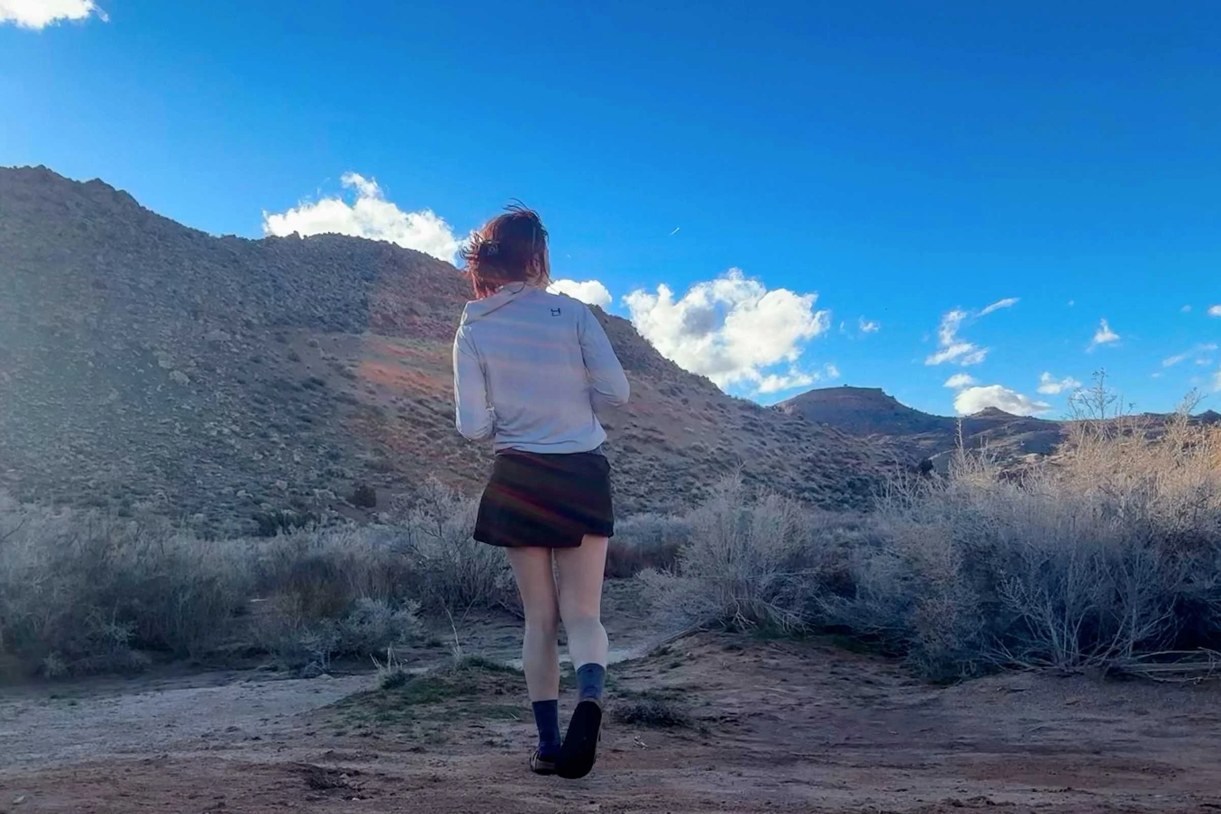 person walking on a desert trail in birkenstock arizona sandals