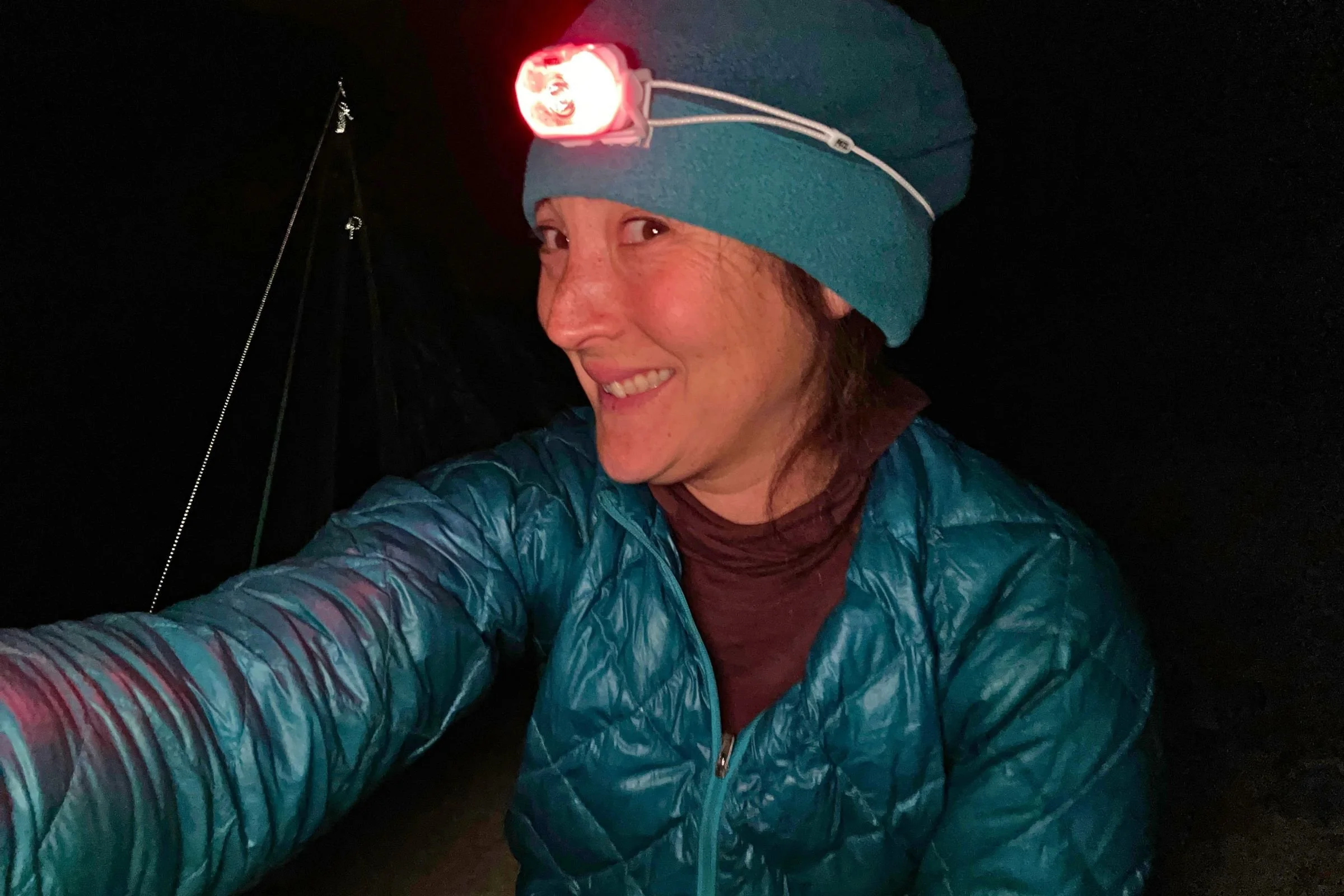 The author wearing the Petzl Swift LT headlamp in the dark.
