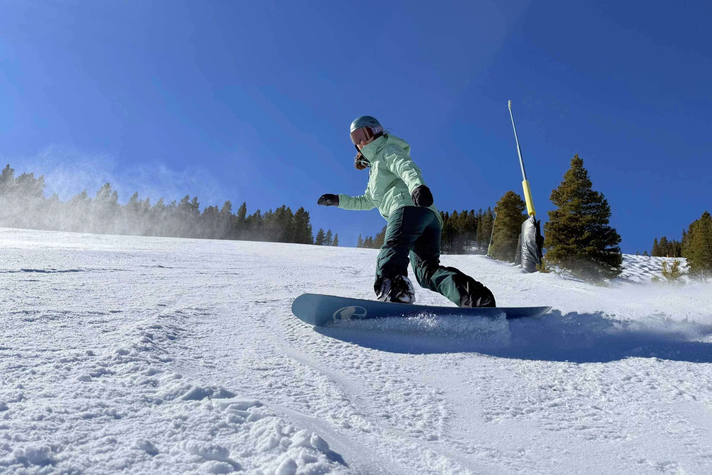 Snowboarder wearing Burton Embark Insulated snowboard jacket riding on a snowy mountain slope in Breckenridge.