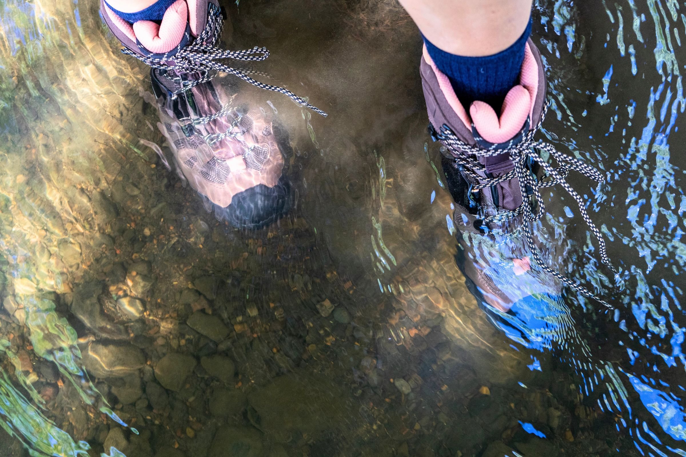 Testing a pair of hiking boots by wading through a creek
