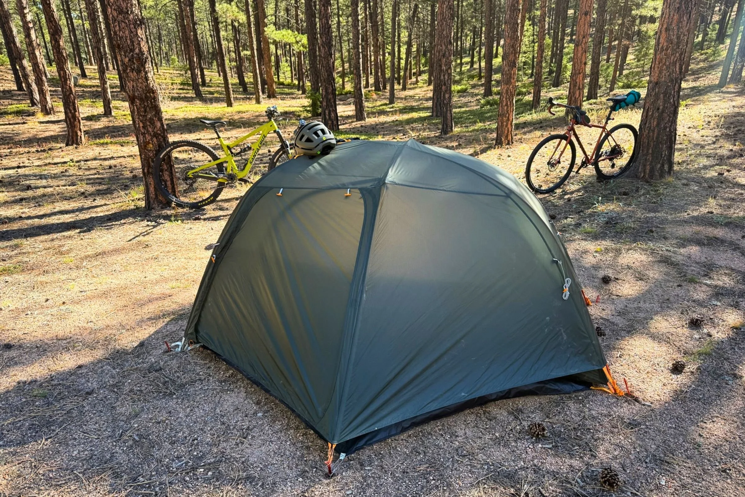 The HyperBead fabric stays more taut than previous Big Agnes rainflys as shown on this copper spur bikepacking tent in the woods .