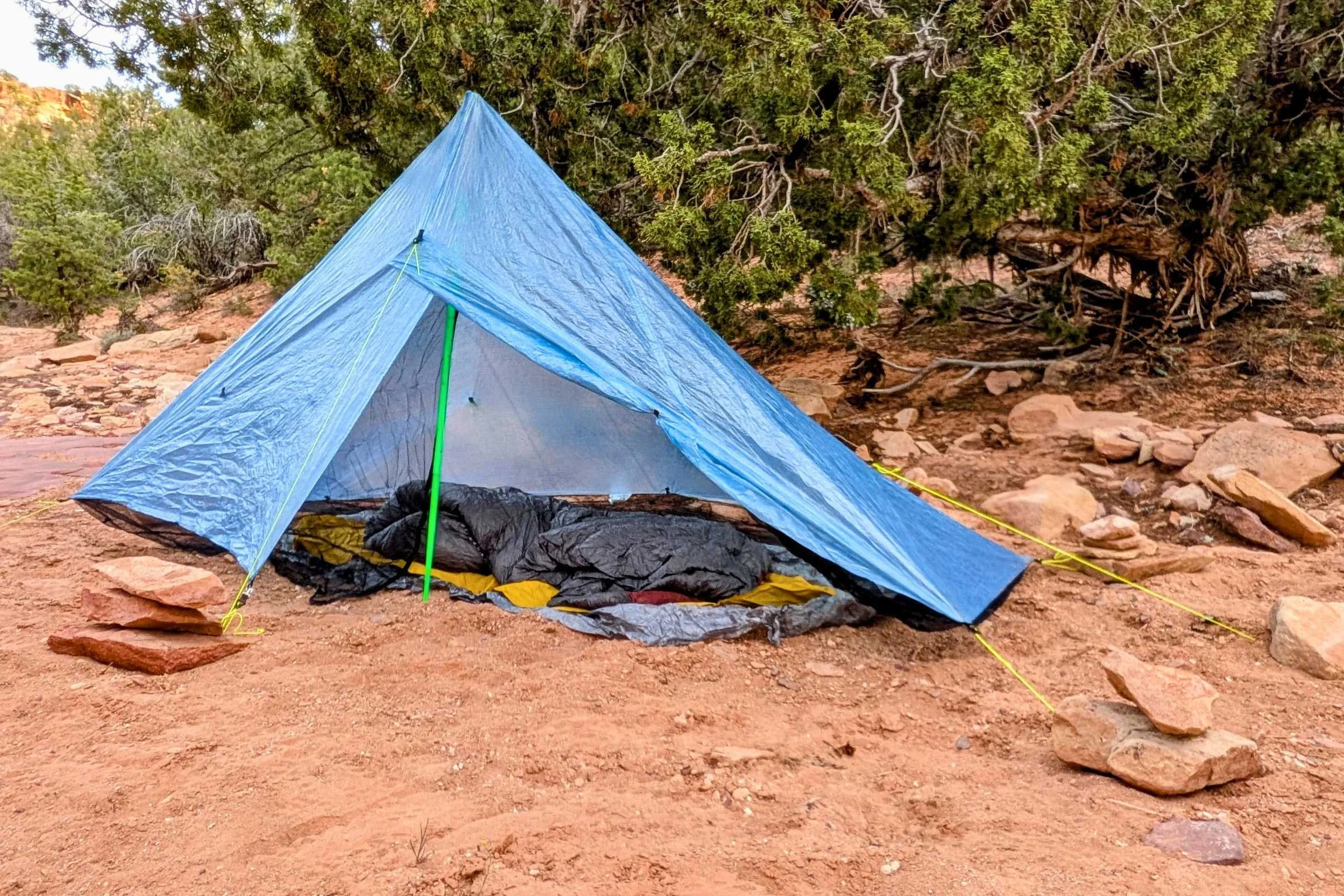 Zpacks Hexamid Ultralight Tent positioned on the side of a mountain in rugged terrain.