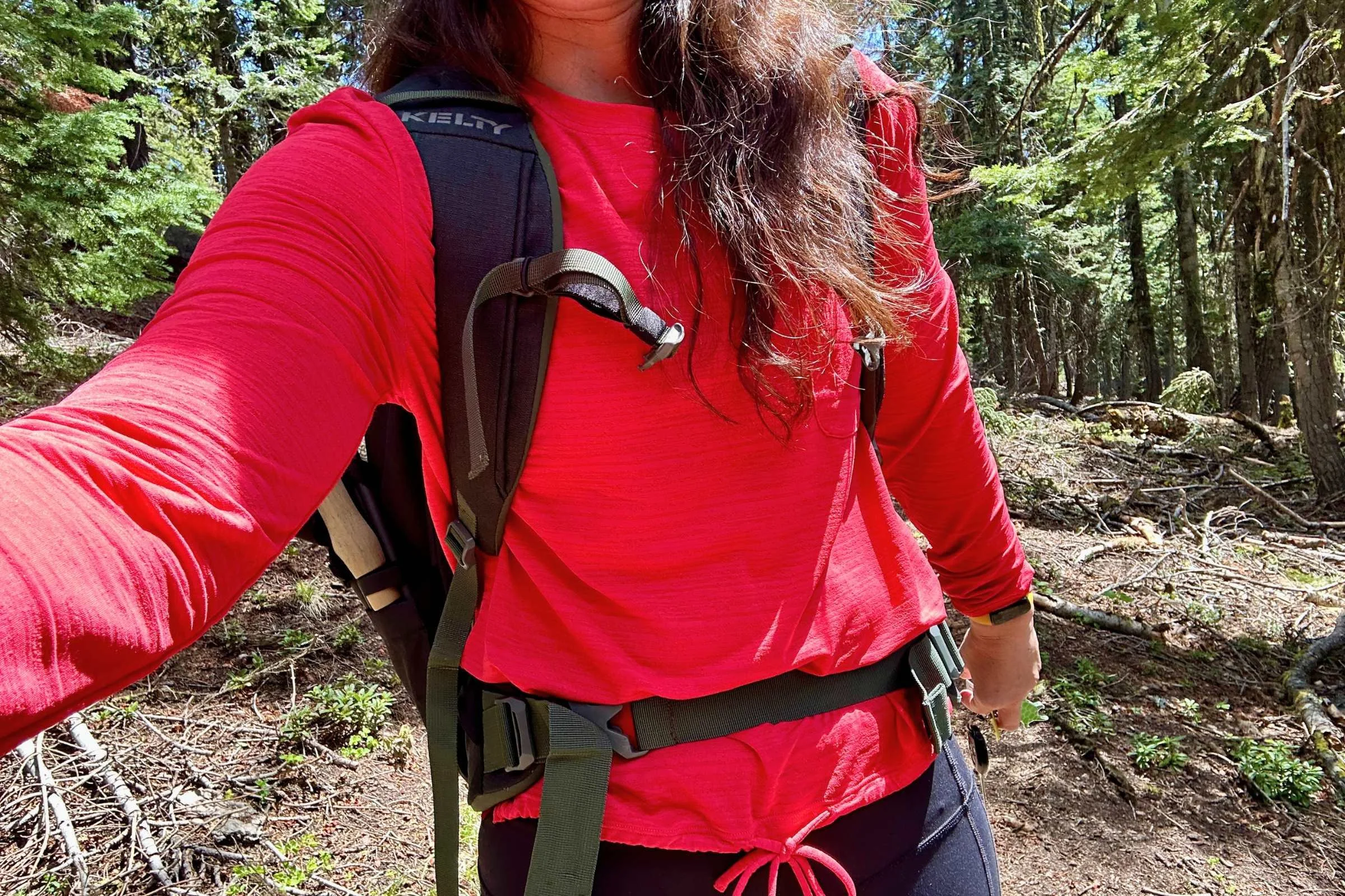 Close-up on the fit of the Title Nine Upland Long Sleeve Sun Shirt and how it pairs with a backpack.
