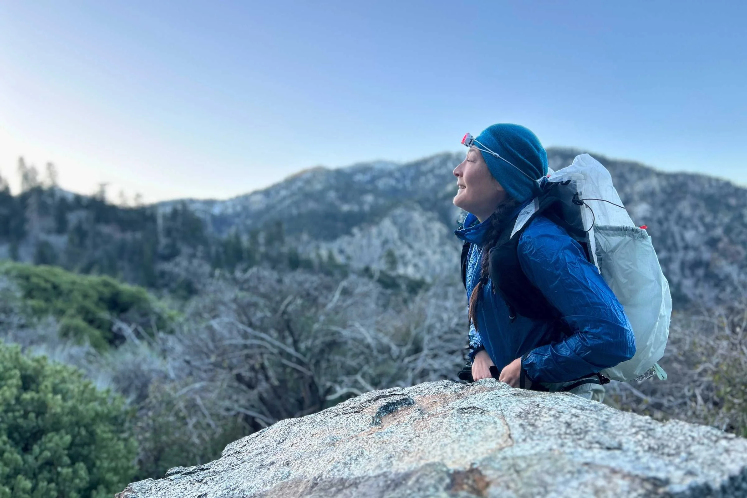 the author backpacking with the mountain hardwear alakazam pack on with mountains in the background