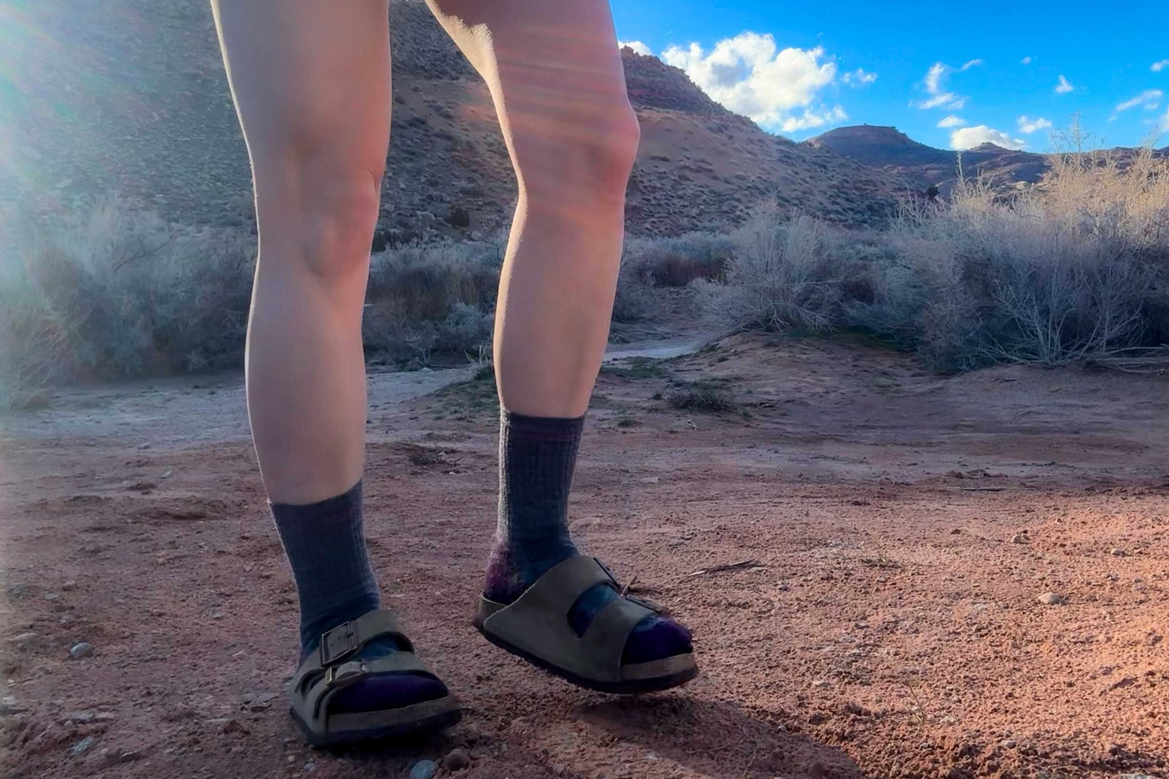 close-up of birkenstock arizona soft footbed sandals on dirt trail