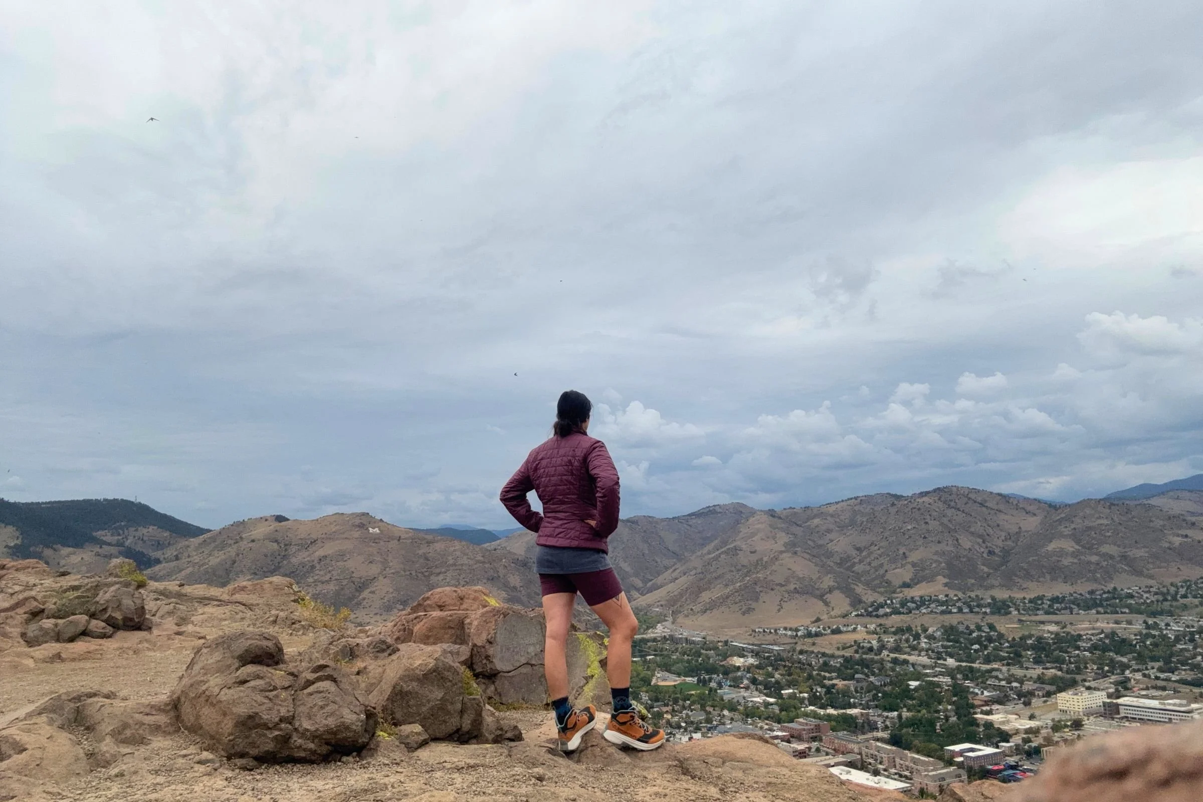 Woman wearing La Sportiva Prodigio Hike LT GTX hiking boots standing on rocky terrain.