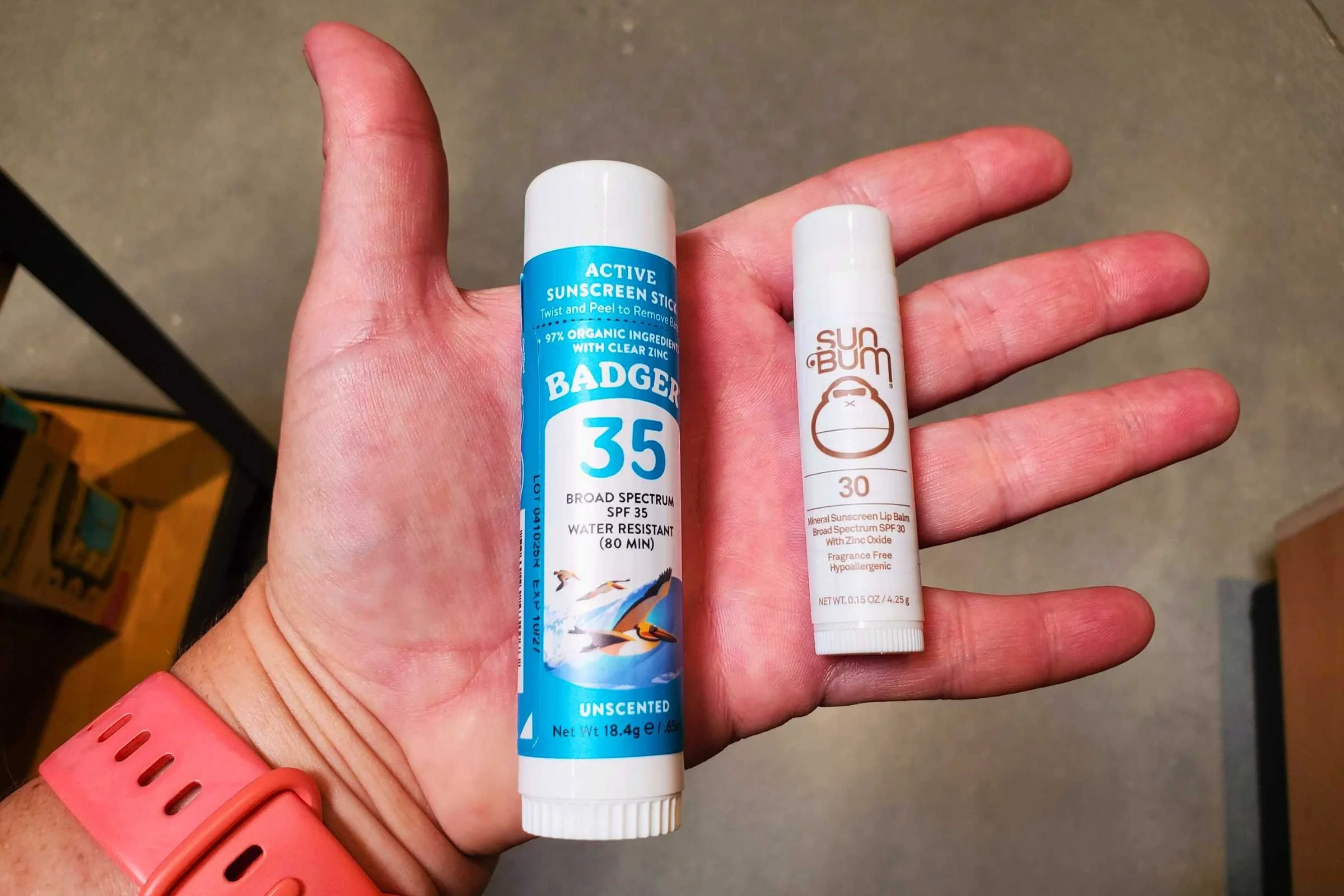 Size comparison of the Badger lip balm and Sun Bum lip balm