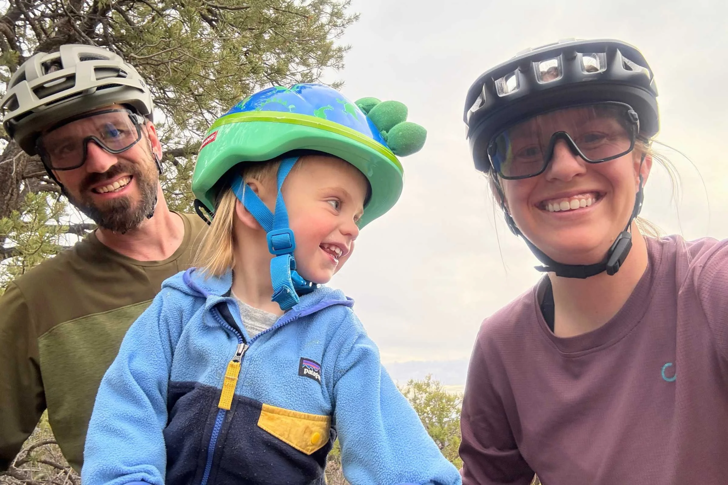 Stasia Stockwell with her husband (left) who spent dozens of days testing the Smith Optics Forefront 3 for this review. But we all know we just want a cool dino helmet like Jasper.