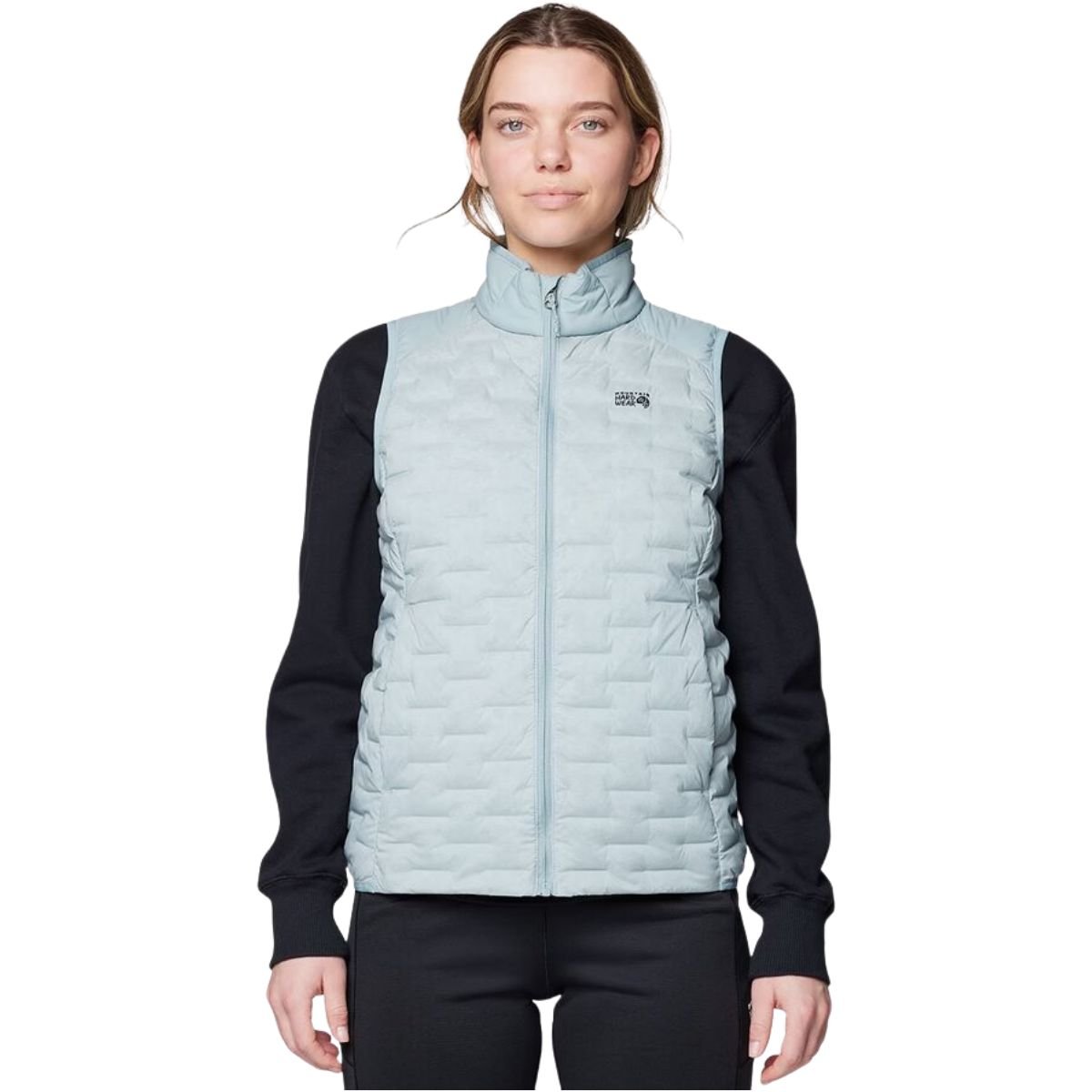 Model wearing a pale green Mountain Hardwear Stretchdown Light Vest
