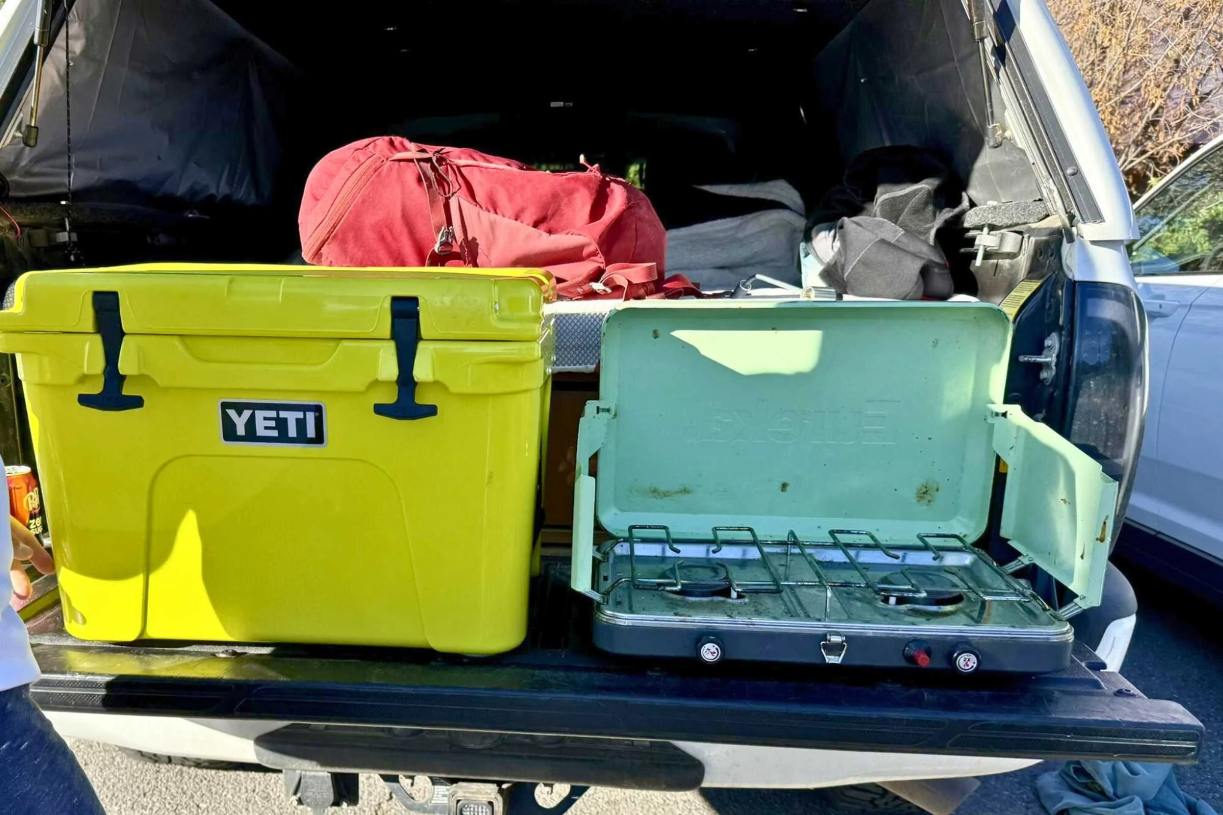 YETI Tundra alongside a campstove on the tailgate of a truck