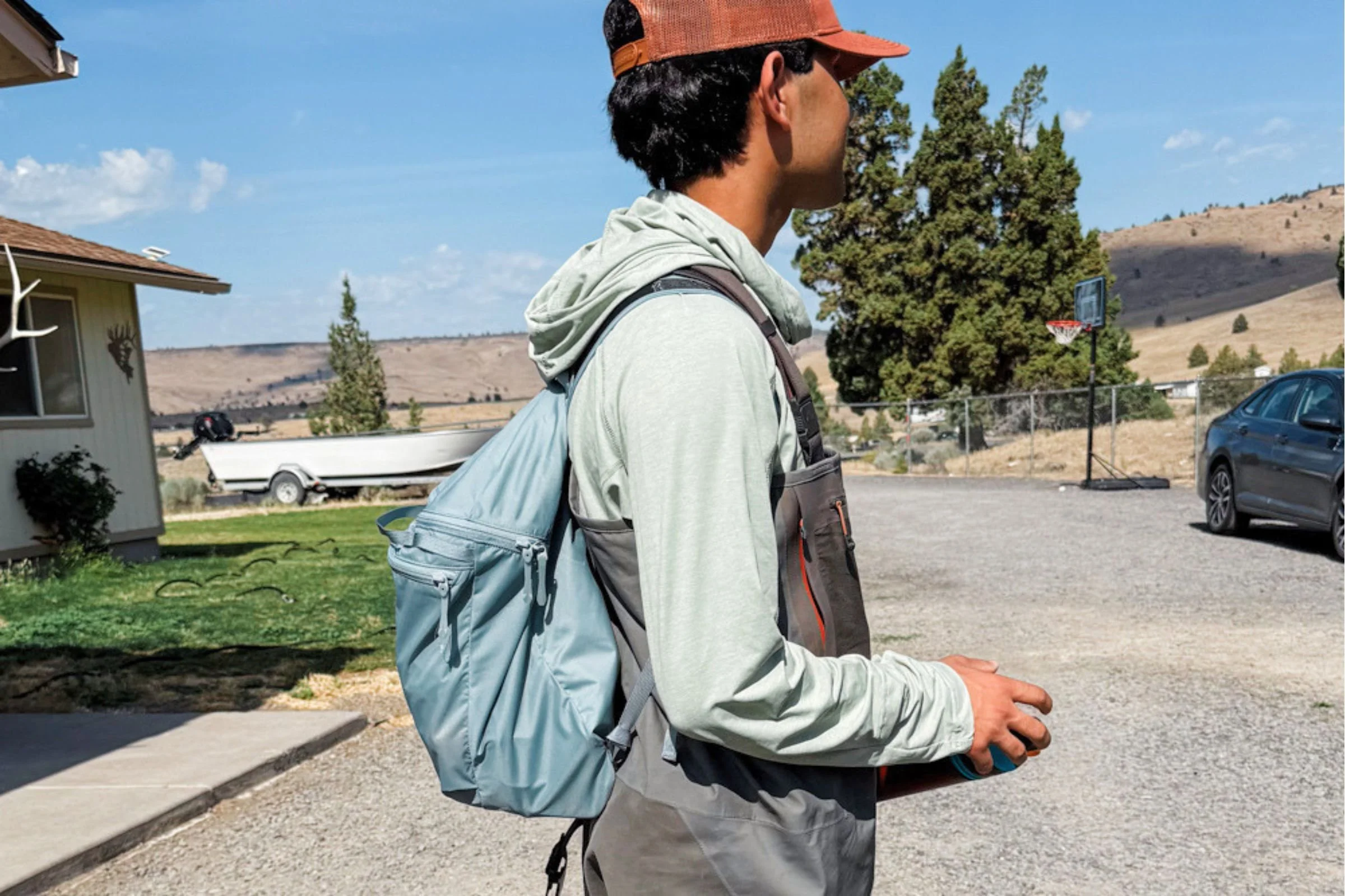 A person wearing a blue Arc’teryx Heliad 15 backpack outdoors.