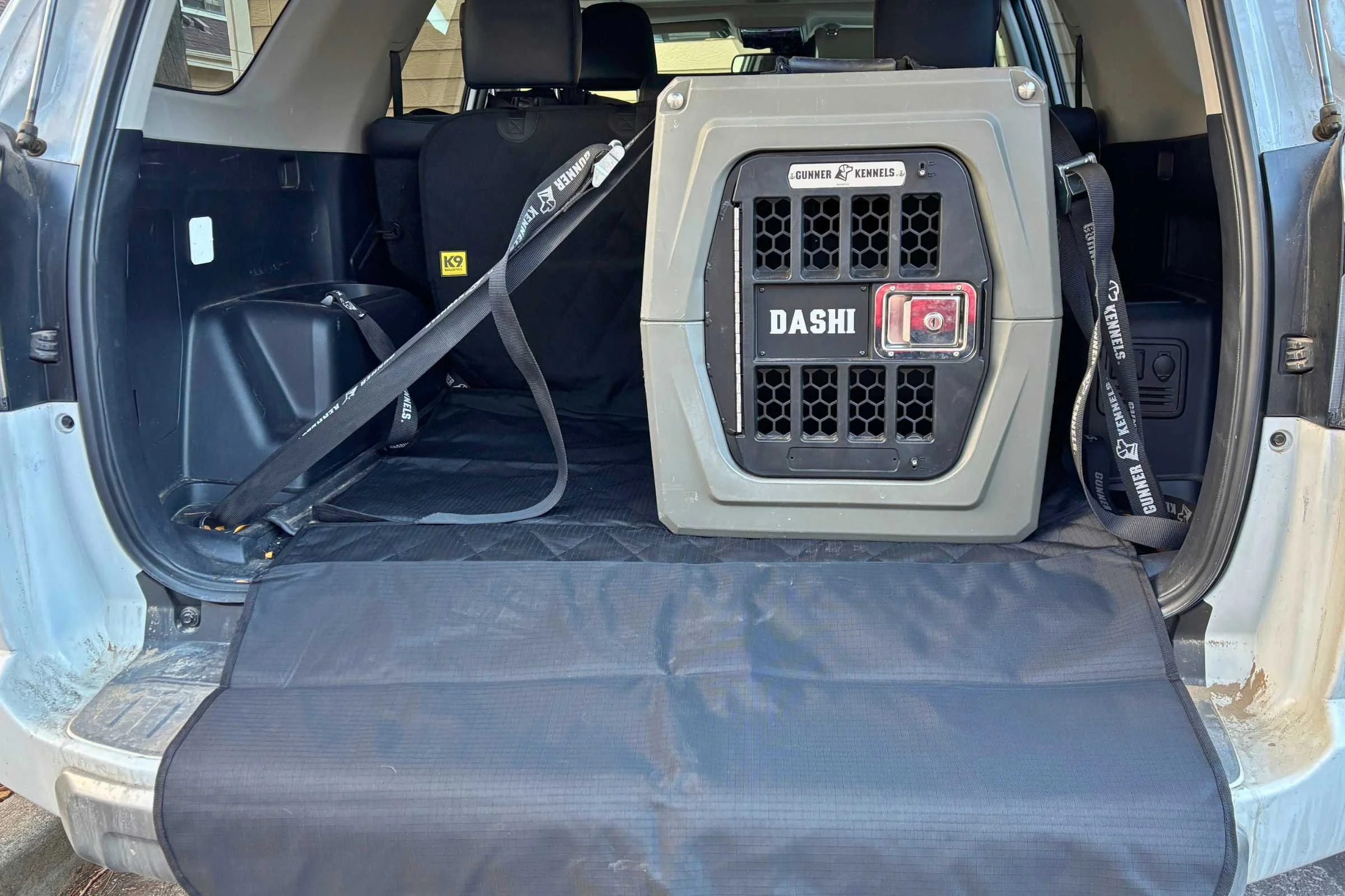 Dog car crate on top of a cargo cover