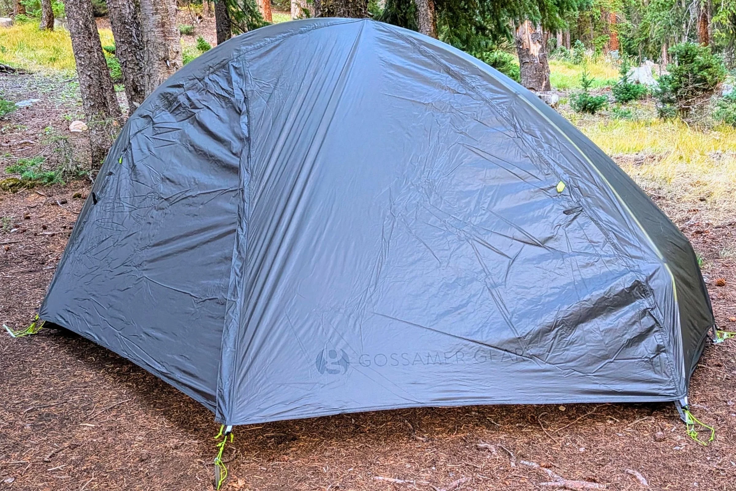 Gossamer Gear The Free with its rainfly closed at a forest campsite.