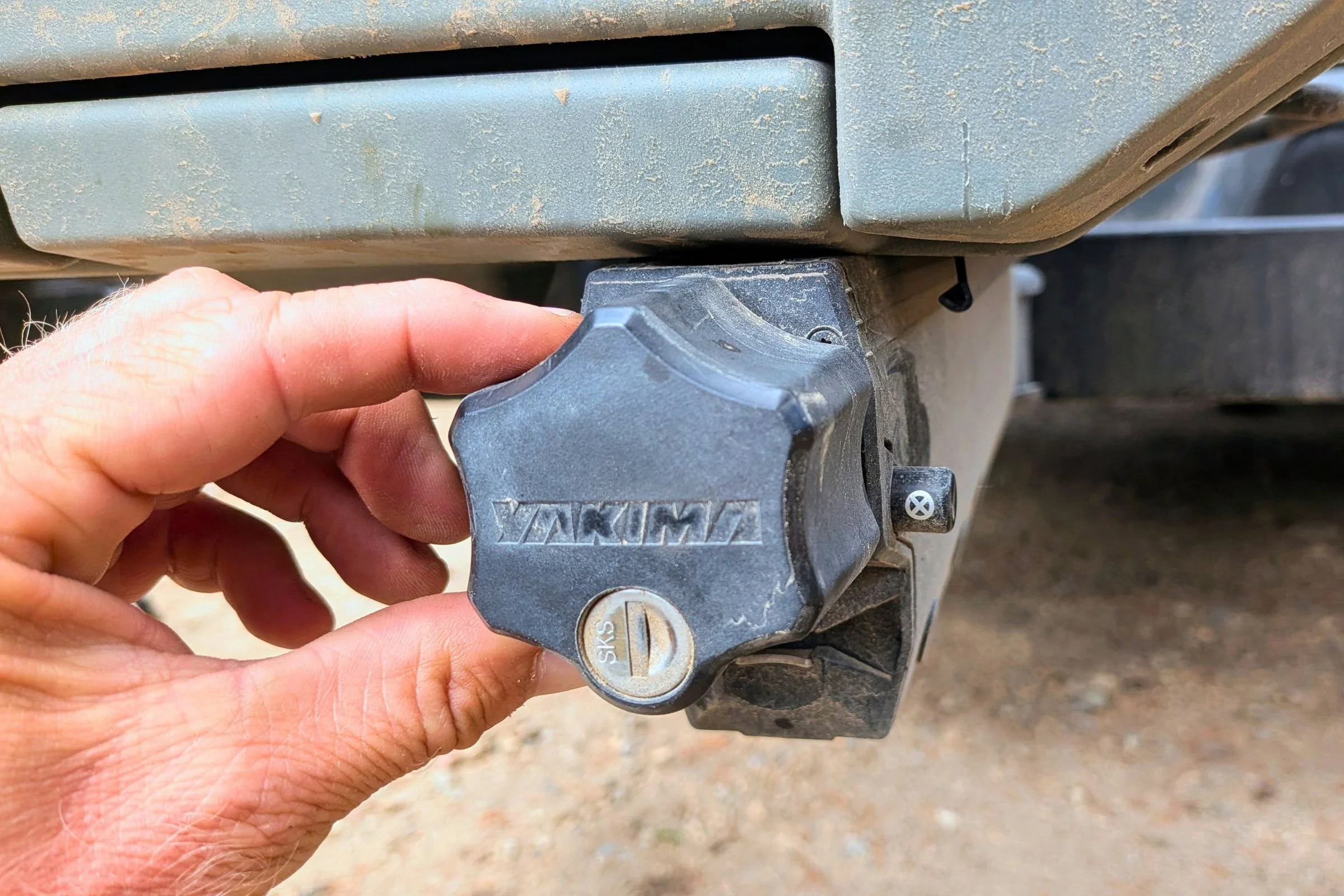 A person operates the lock mechanism on a Yakima EXO Swing mounted to a truck.