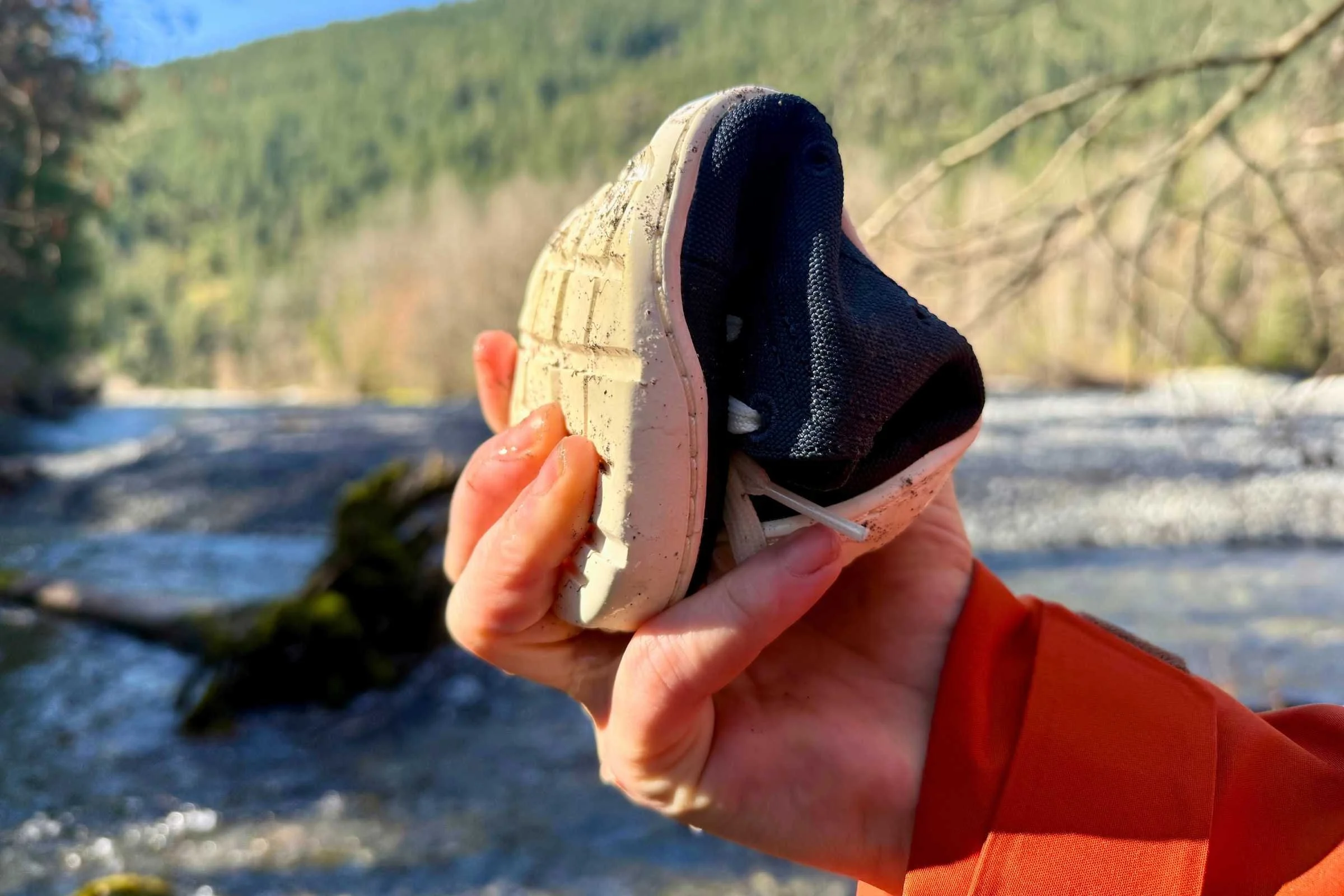 Flexible minimalist water shoe bent in hand