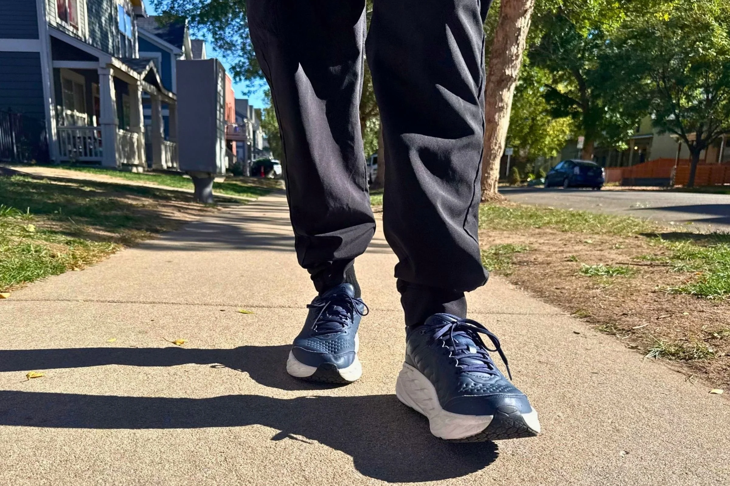 HOKA Bondi SR shown on a person walking along a sidewalk.