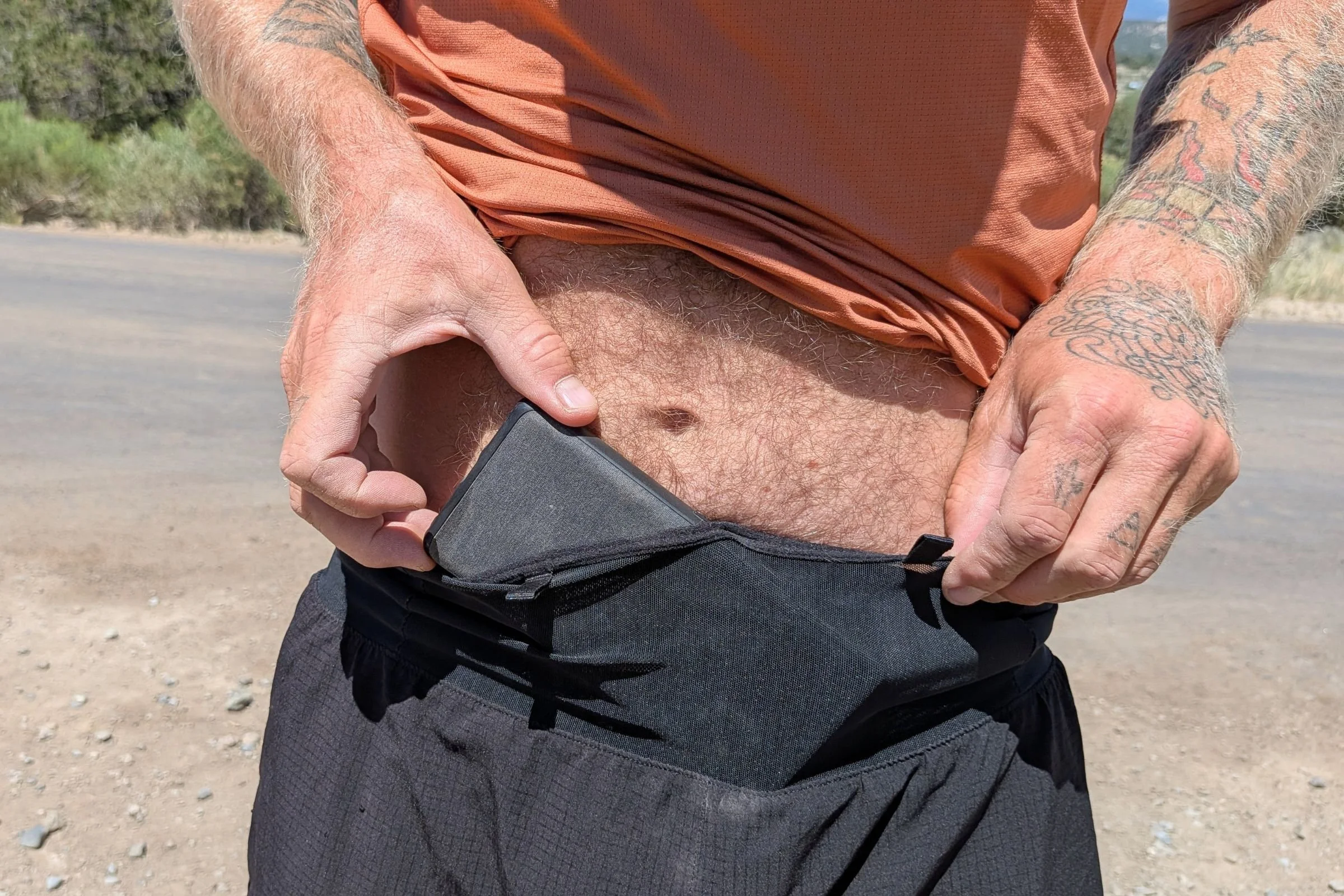 man holding the waistband of Terignota Sendero Shorts.