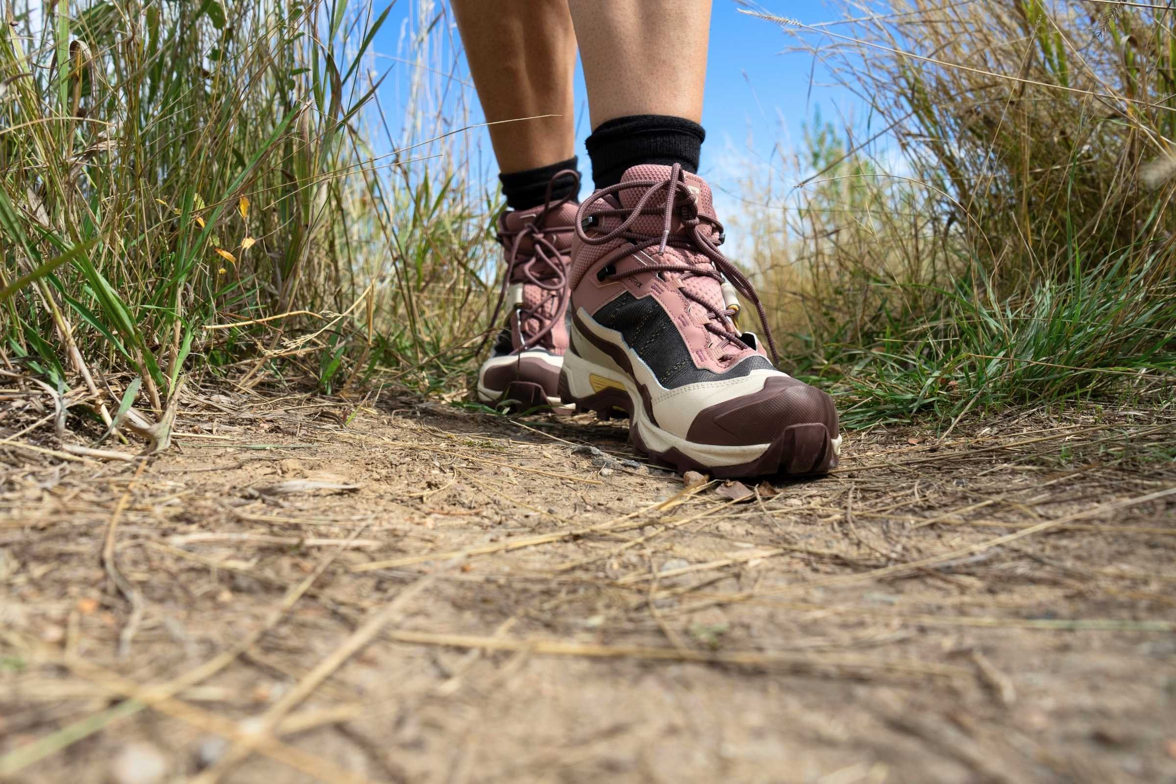 Hiker wearing Salomon X Ultra 5 hiking boots on dirt trail