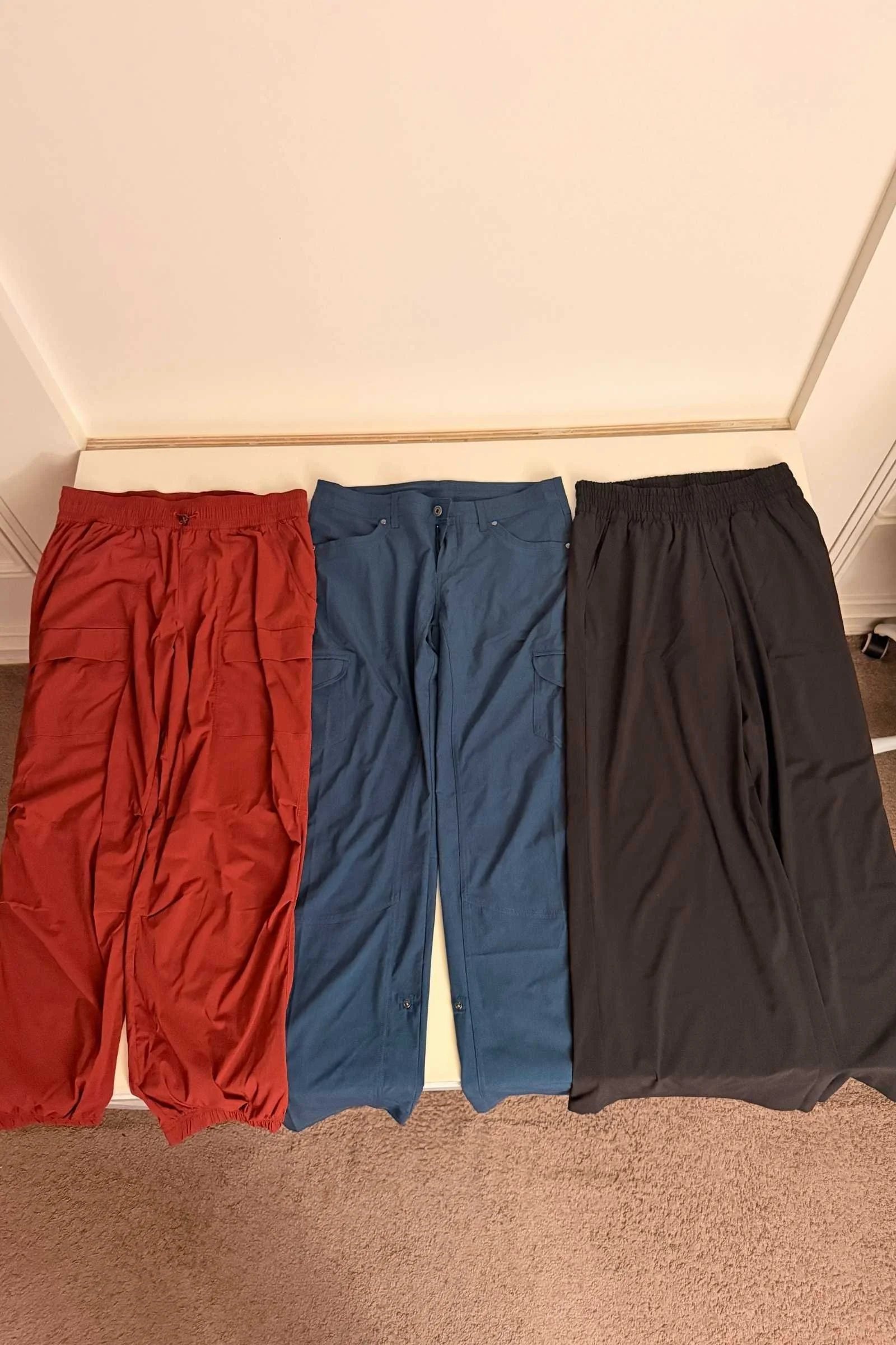 Side-by-side comparison of pocket layouts on three different travel pants