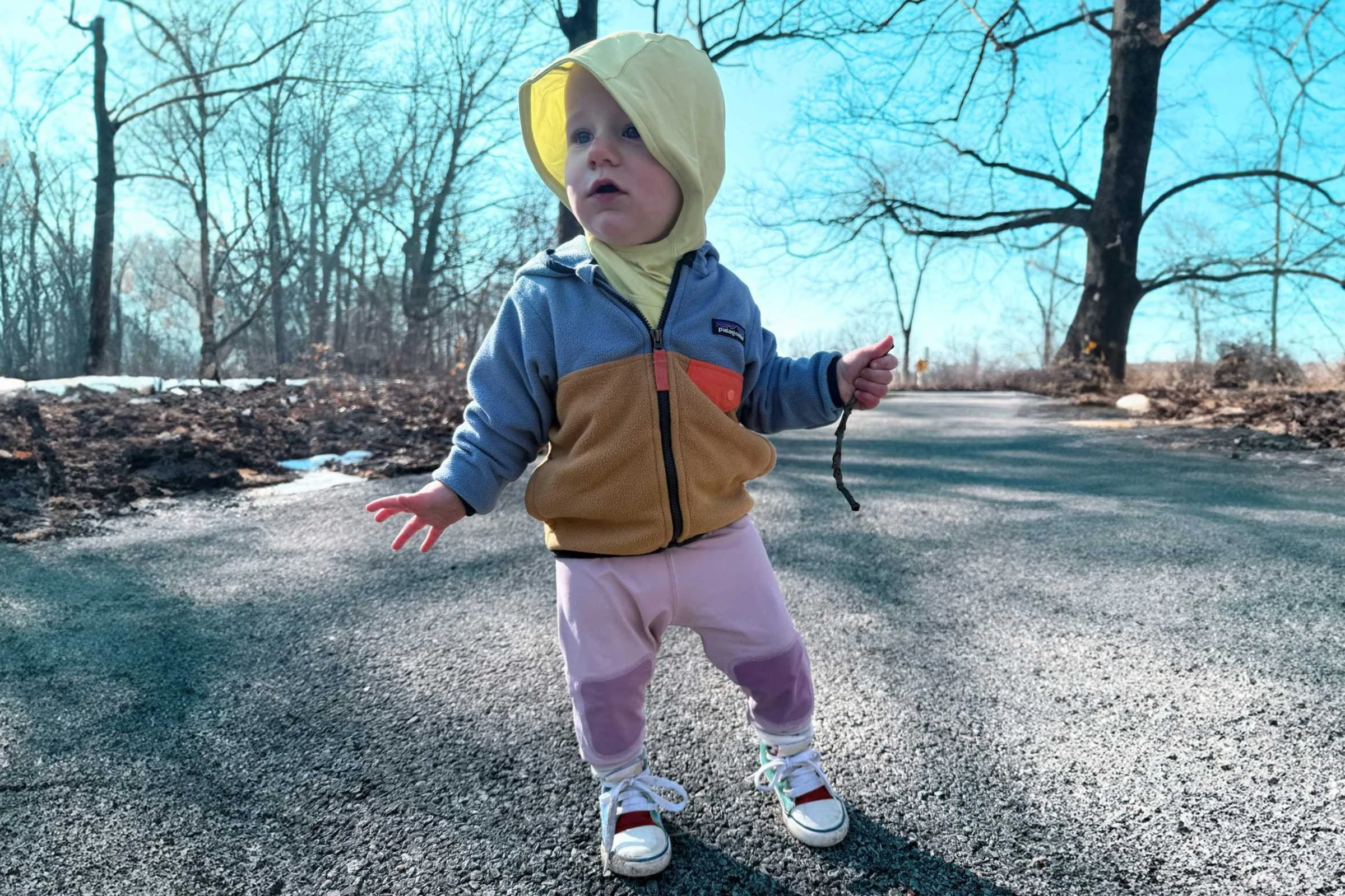 A baby layered up in the spring time wearing the Patagonia Baby Micro D Snap-T Fleece Jacket. Photo courtesy Erica Zazo