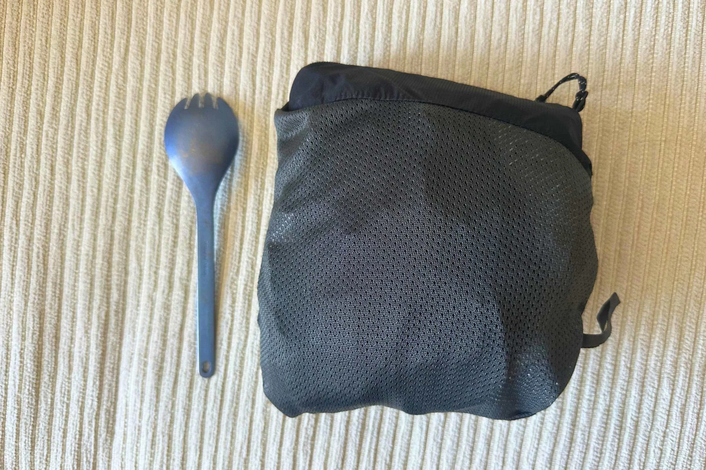 Outdoor Research Helium UL rain pants packed next to spork