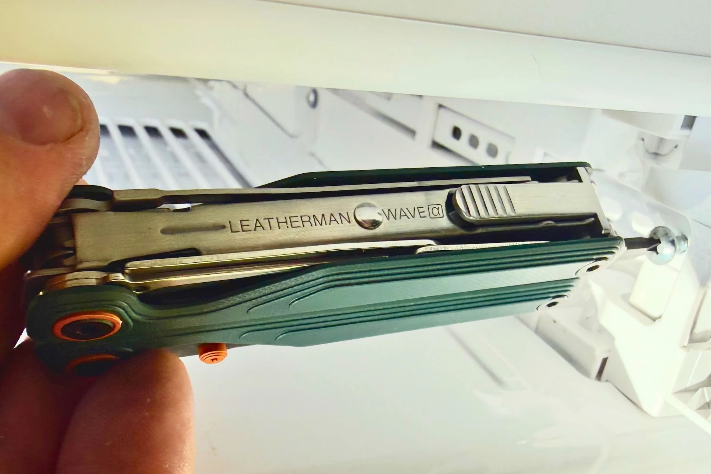 Using the bit driver on the Leatherman Wave Alpha to install an air conditioner in Colorado’s blistering summer heat. Courtesy Chris Meehan