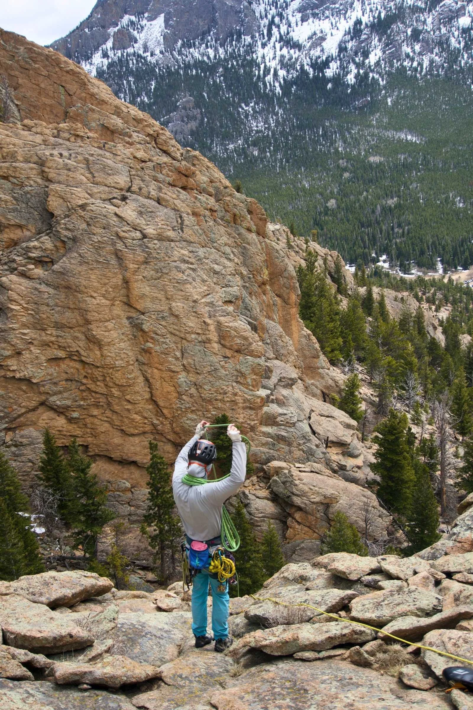 A climber wearing the Cotopaxi Halcon in an alpine environment.