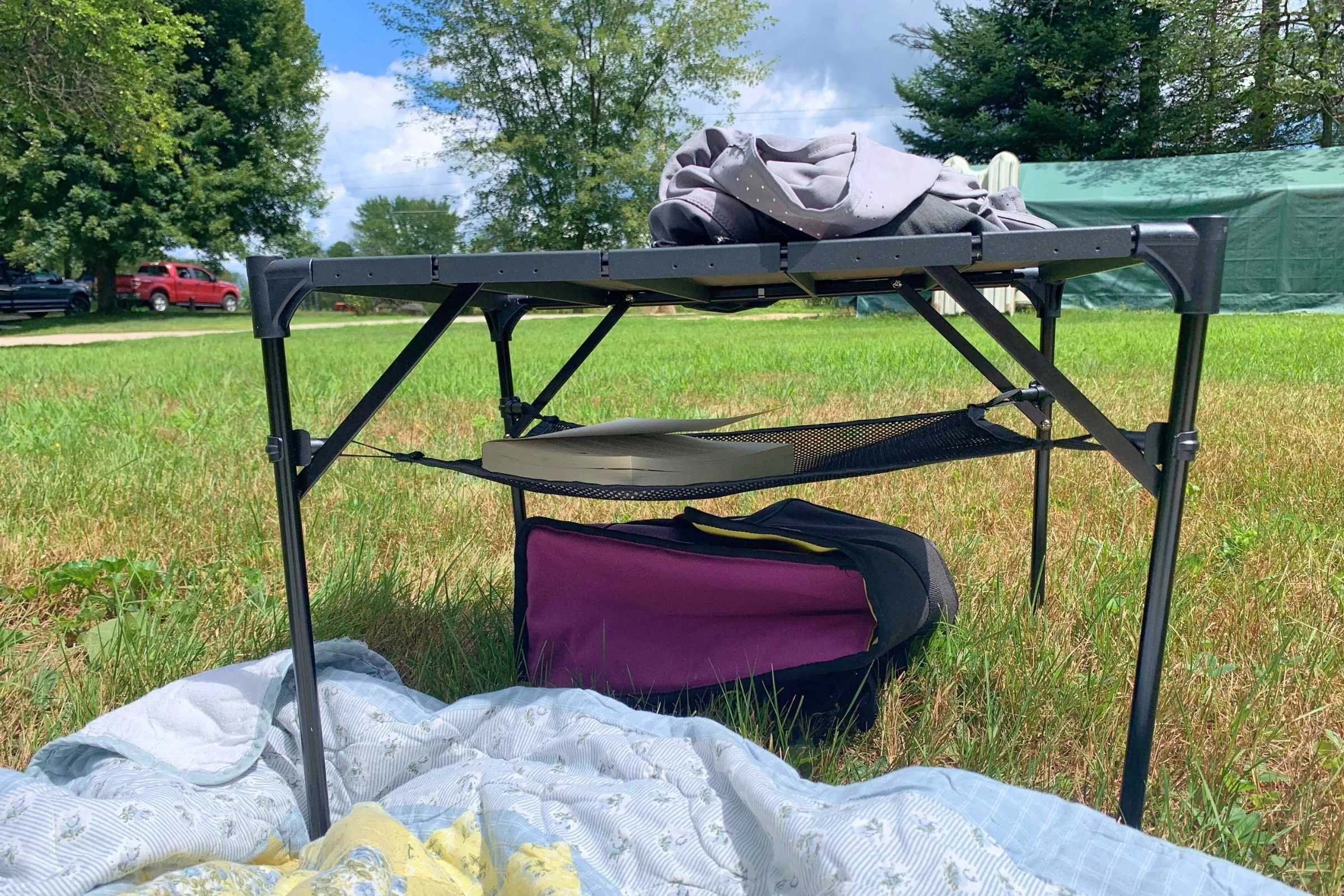 The Rock Cloud Portable camping table on a picnic in Maine. Its storage basket underneath has room for a book.