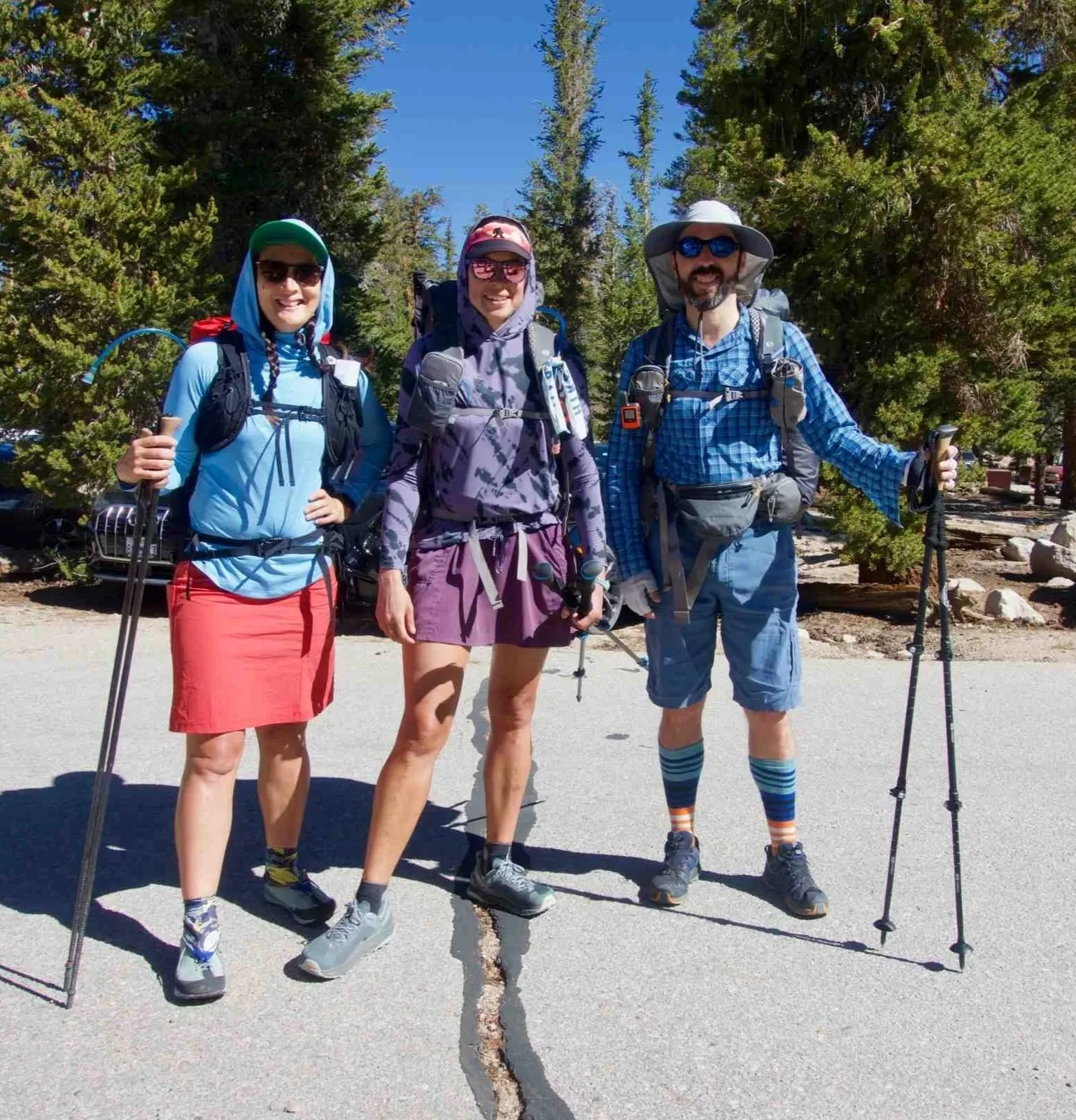Three backpackers wearing sun shirts