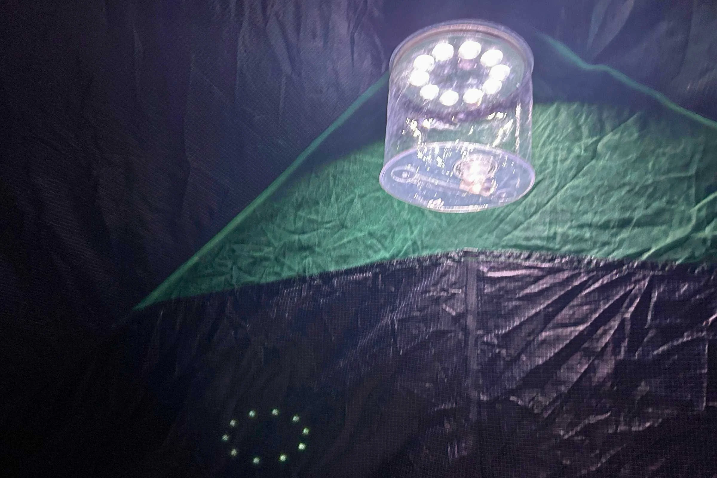 There is a hook to hang a lantern and a pocket that can hold a headlamp.