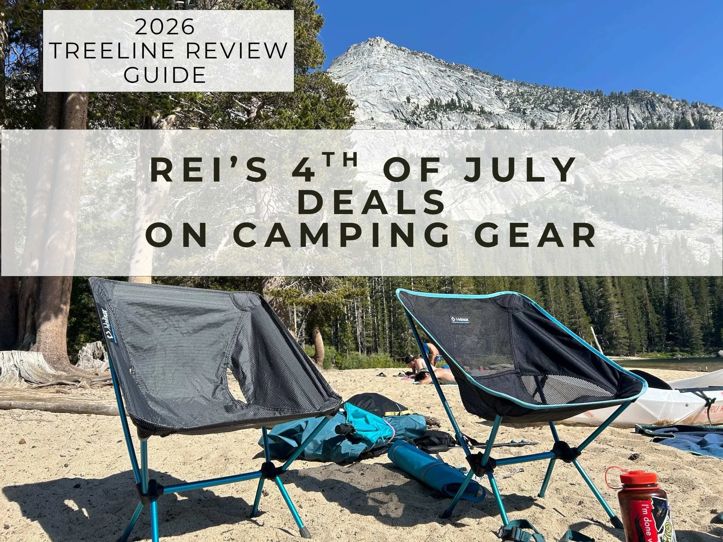 Two camping chairs on the sandy shore of a mountain lake