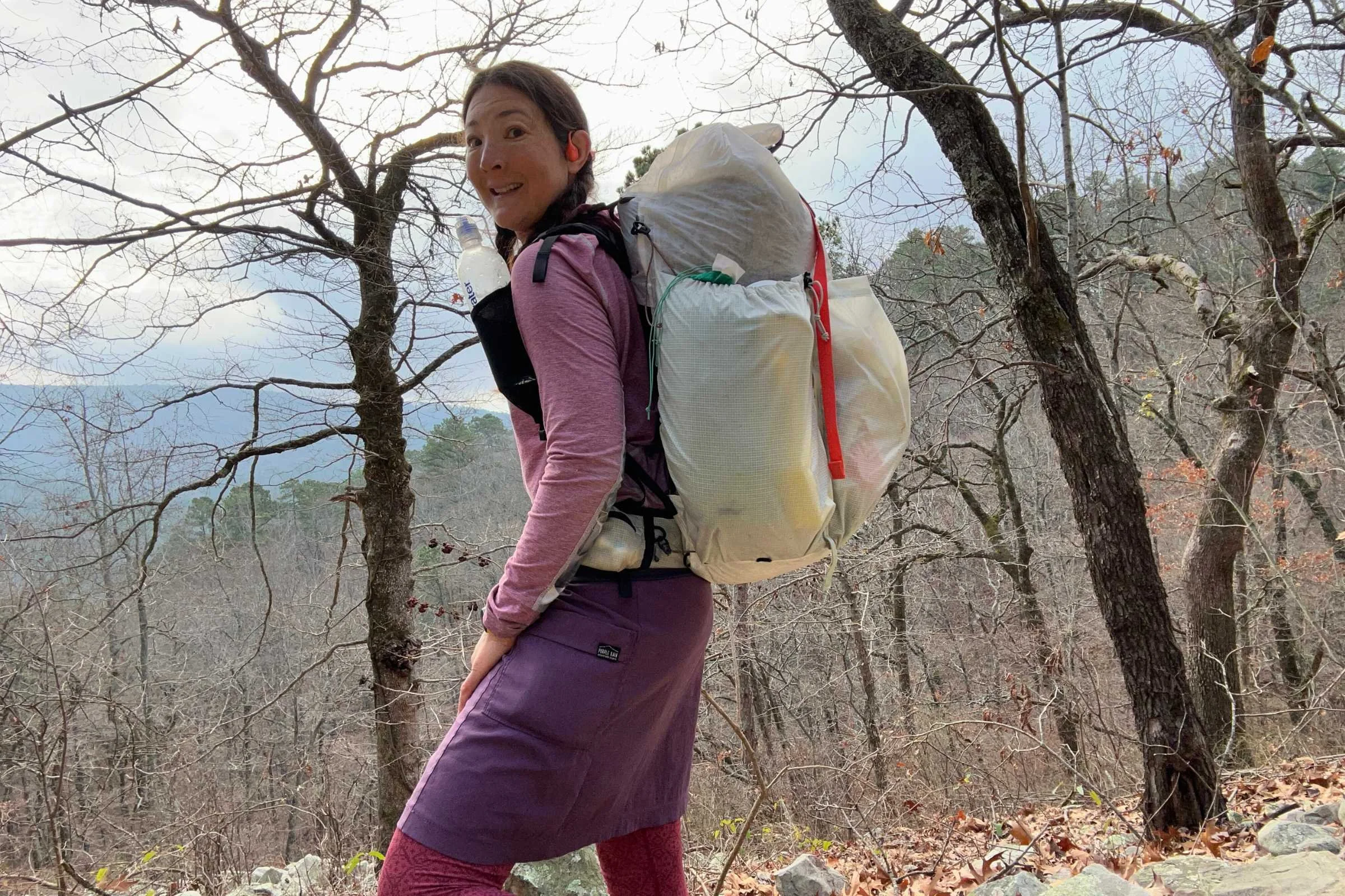 the author backpacking with the mountain hardwear alakazam pack with bare trees in the background