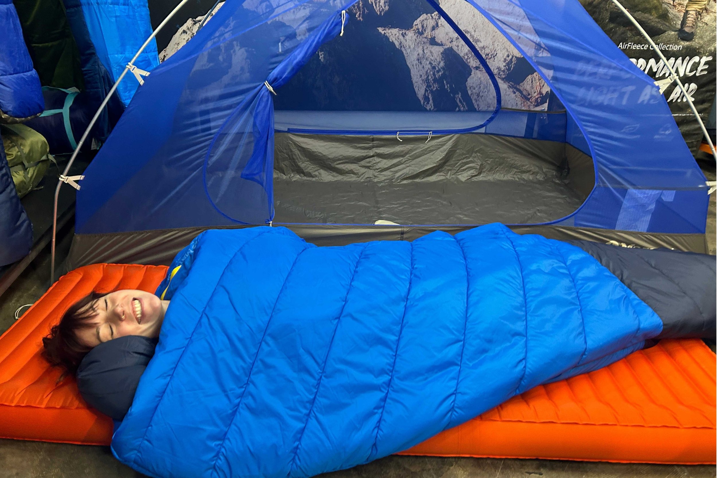 Treeline Review editor Becca wrapped up in the zipperless sleeping bag and the new Marmot Tungsten UL 2 tent.