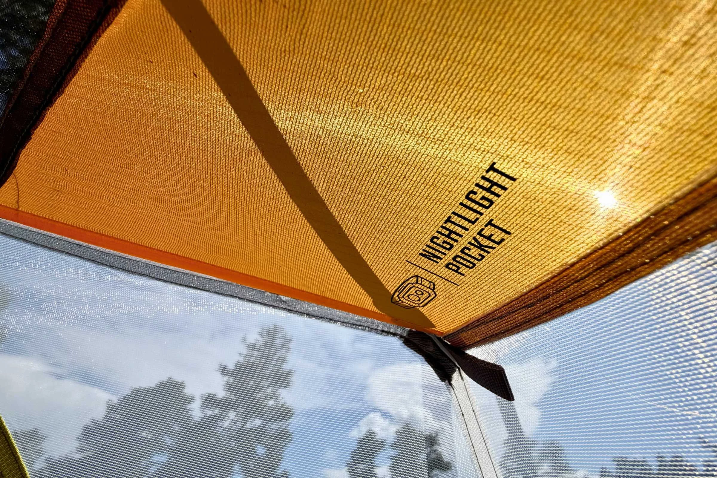There are two included “nightlight” pockets to add a headlamp for reading overhead or using a headlamp hands-free inside the tent.