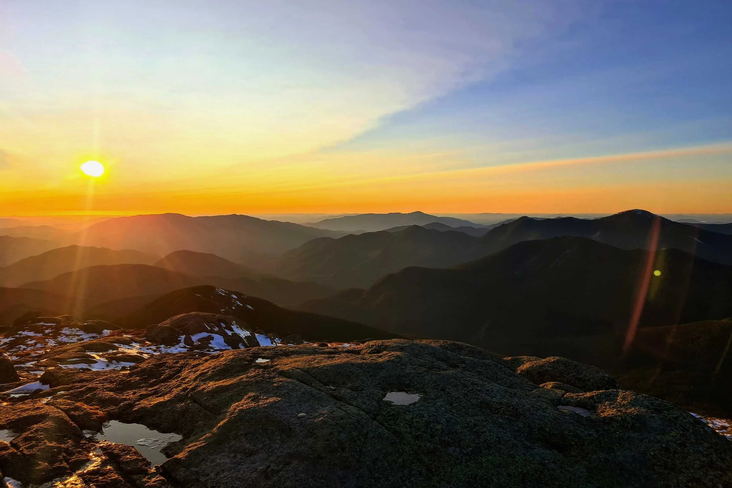 The alpine glow and sharp mountain ranges visible from Mt Marcy. Photo by Aubri Drake.