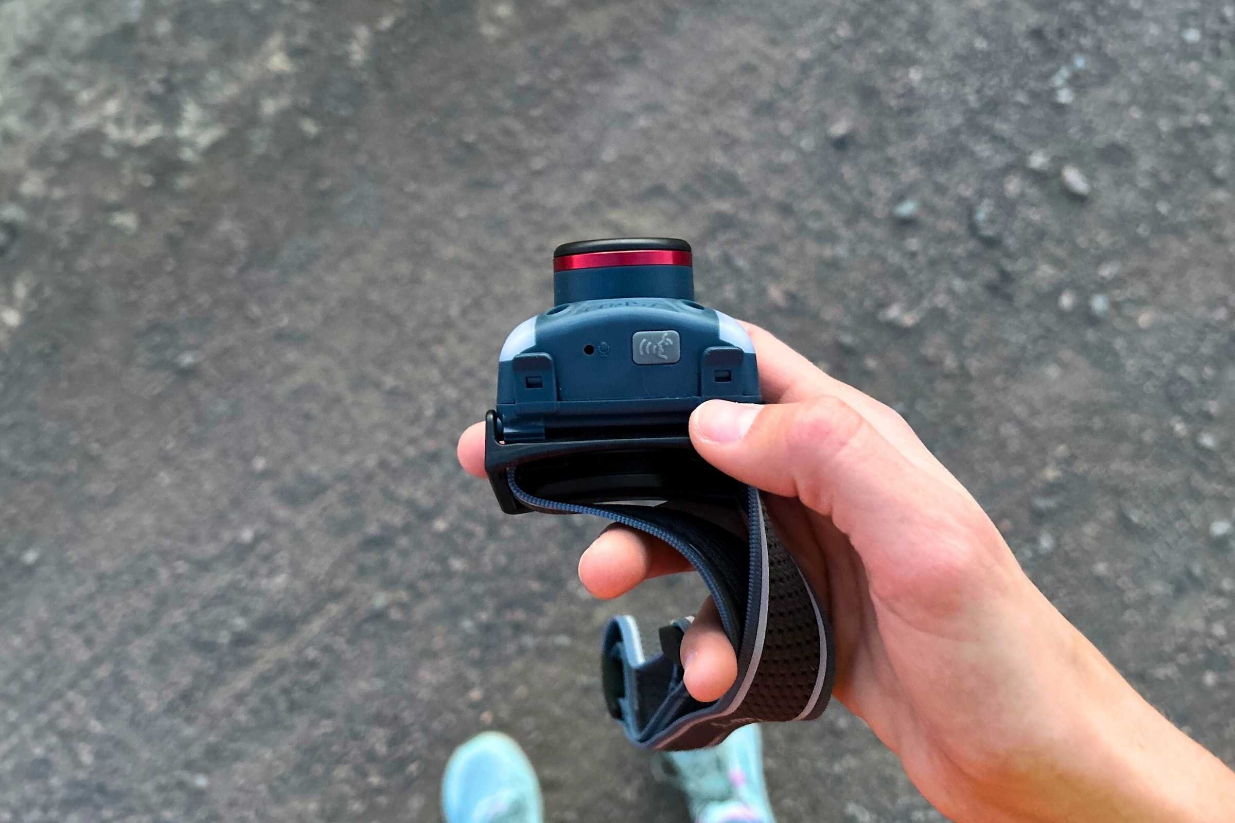 On the underside of the headlamp (facing down when you are wearing it), is the voice control activation button, as well as the mic. In this photo the voice control is off.