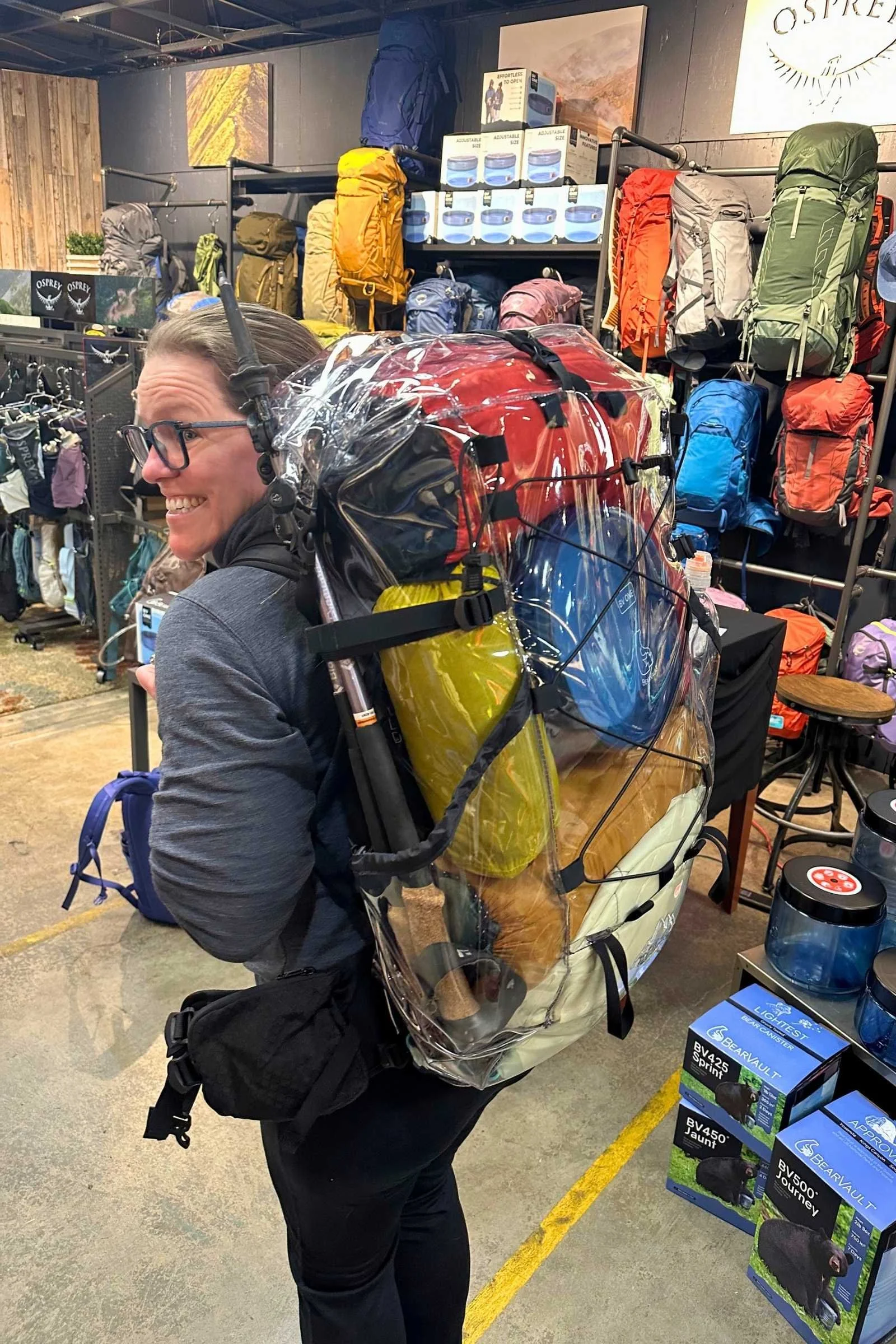 CLear backpacking pack full of gear including the Bearvault BV ONE bear canister