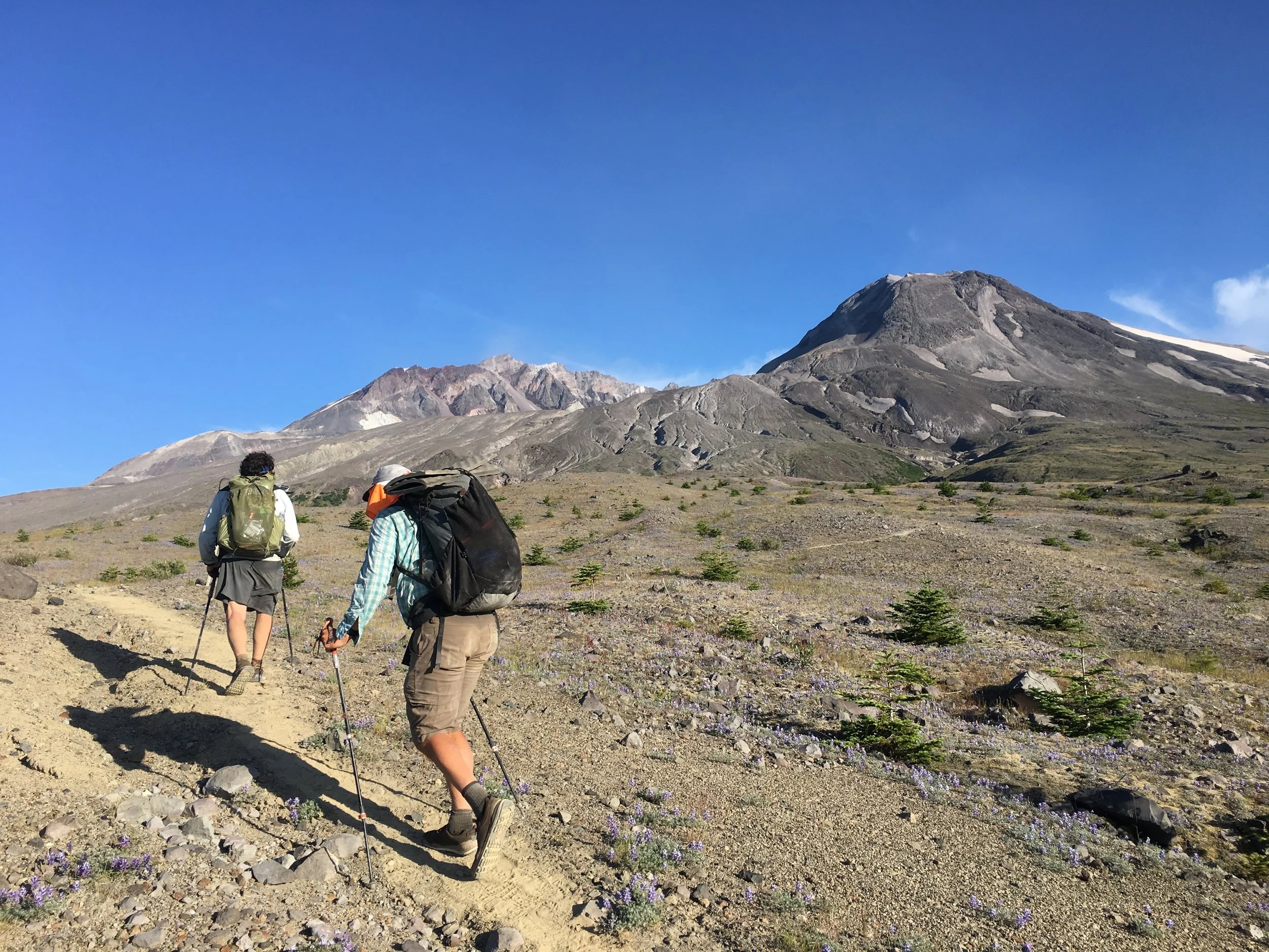 Two hikers on a high desert trail hiking in Darn Tough Hiker Micro Crew Midweight hiking socks