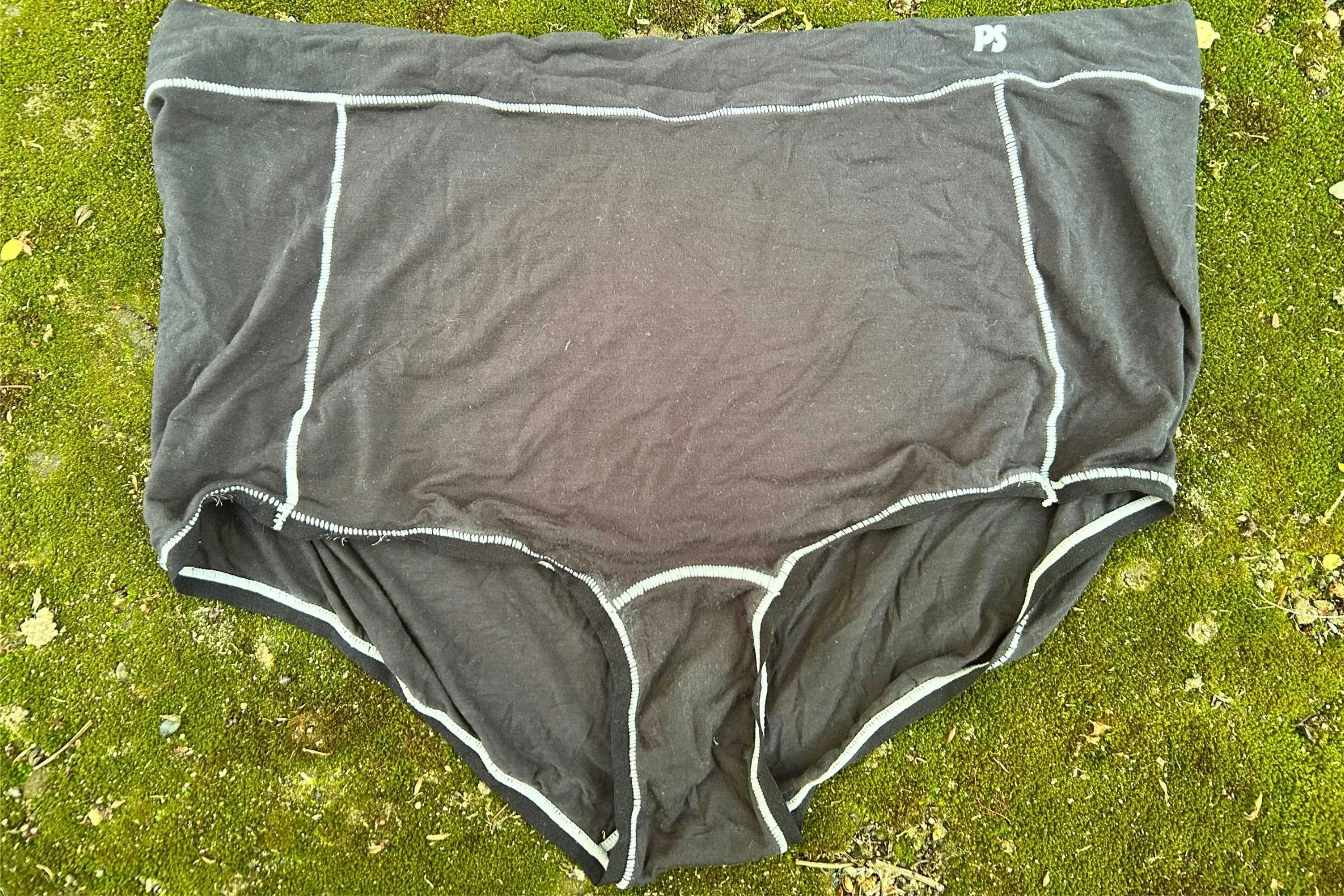 Paradis Natural Fiber Boyshort after multiple use/washes displayed on a mossy background