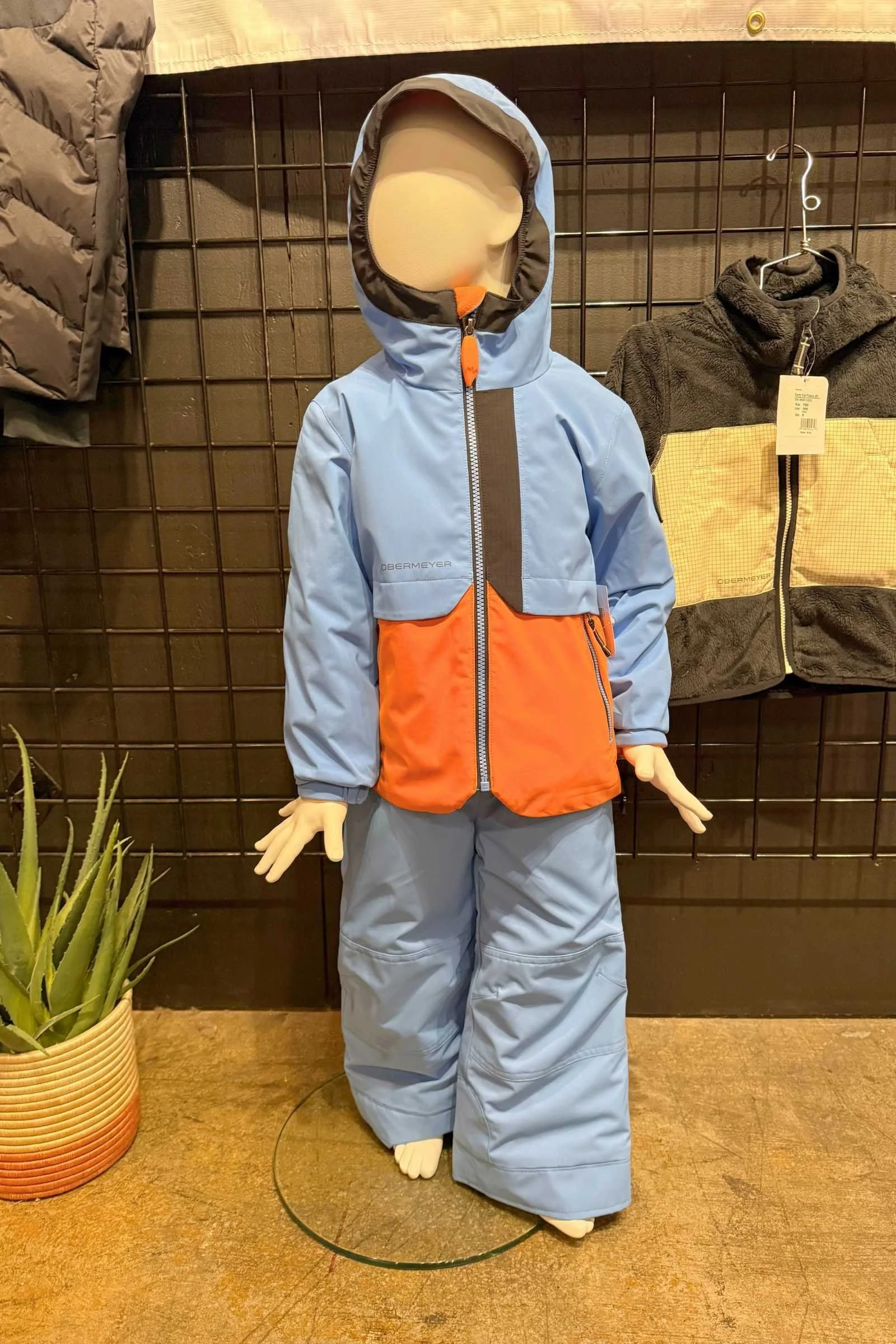 Obermeyer Foxtail kids ski jacket and bib set on display at Outdoor Market Alliance Winter 2026