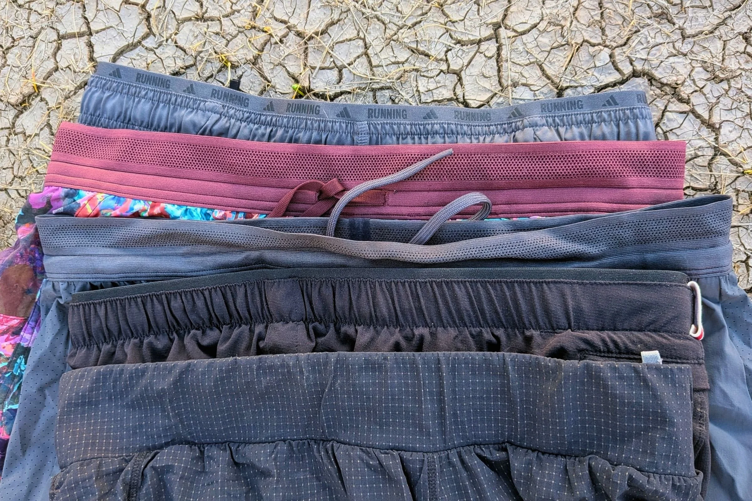 A close-up of the waistband on the Adidas ADI 365, Janji AFO Middle, On Performance, Tracksmith Twilight, and REI Swiftland shorts.
