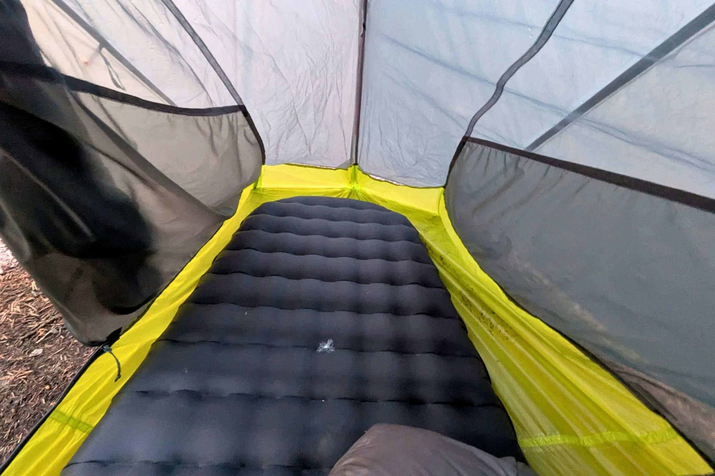An interior view of the Big Agnes Tiger Wall UL1 Bikepack Tent with a black sleeping pad.