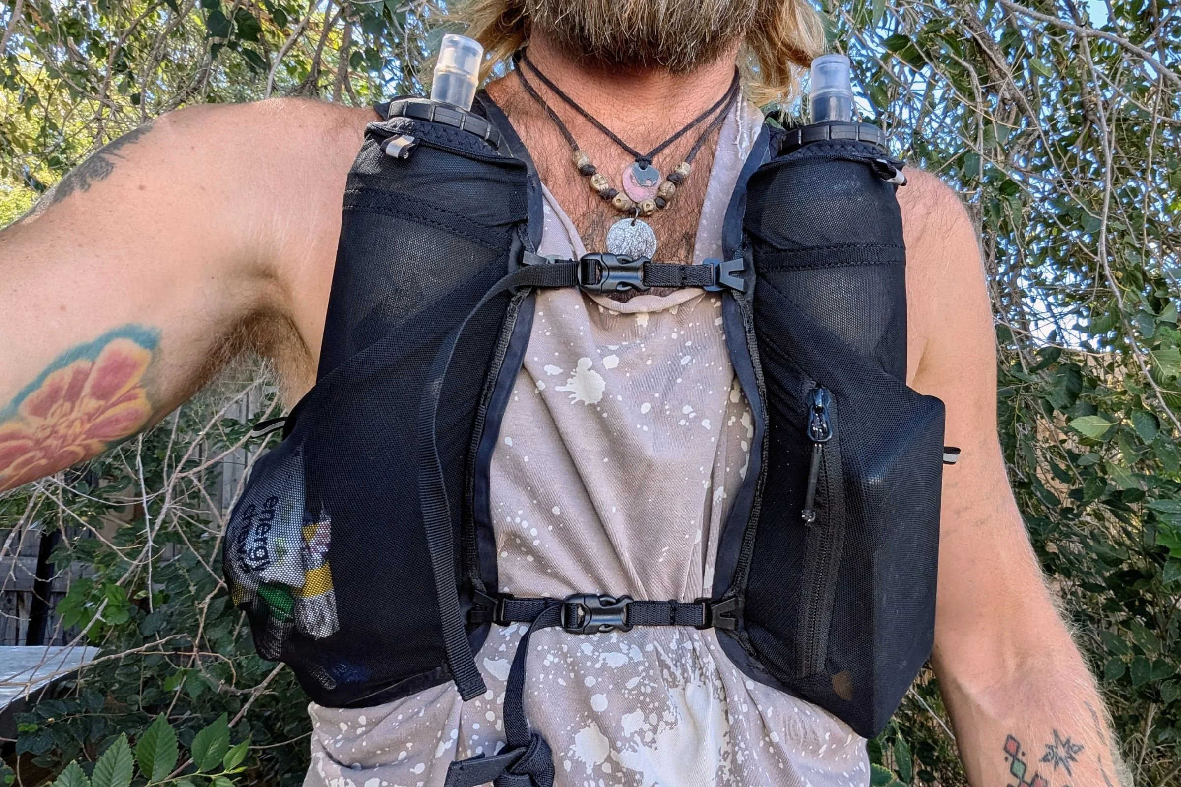 A bearded man wears the Black Diamond Distance 15 Backpack.