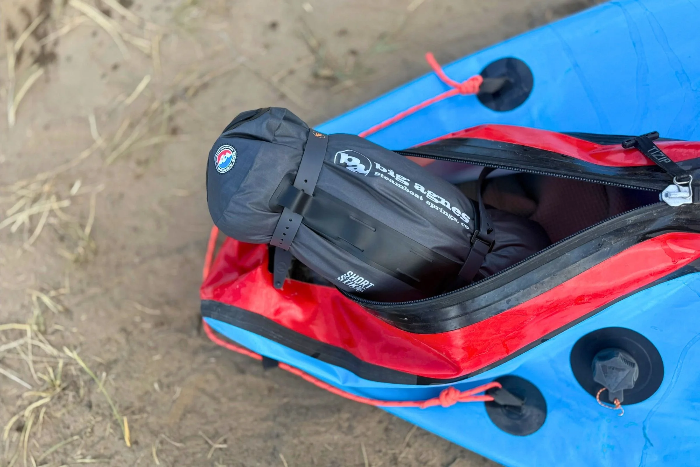 The dry bag stuff sack for the tent makes it easy to fit tight, narrow spaces, like the inside of this Alpacka Gnarwhal packraft.