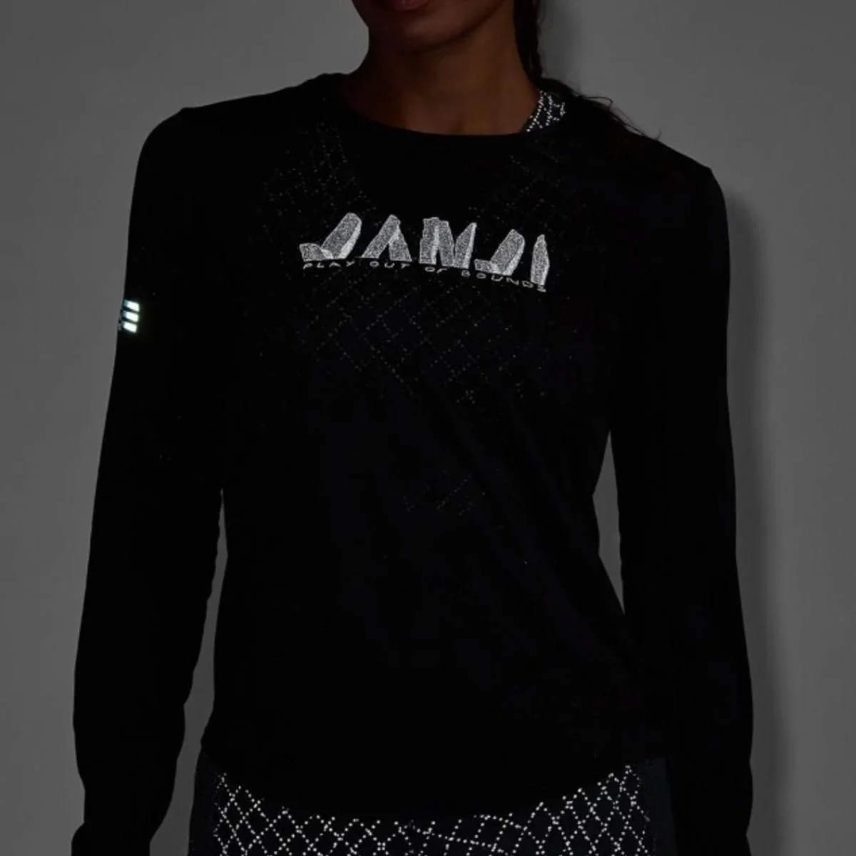 dark background with reflective janji shirt on runner