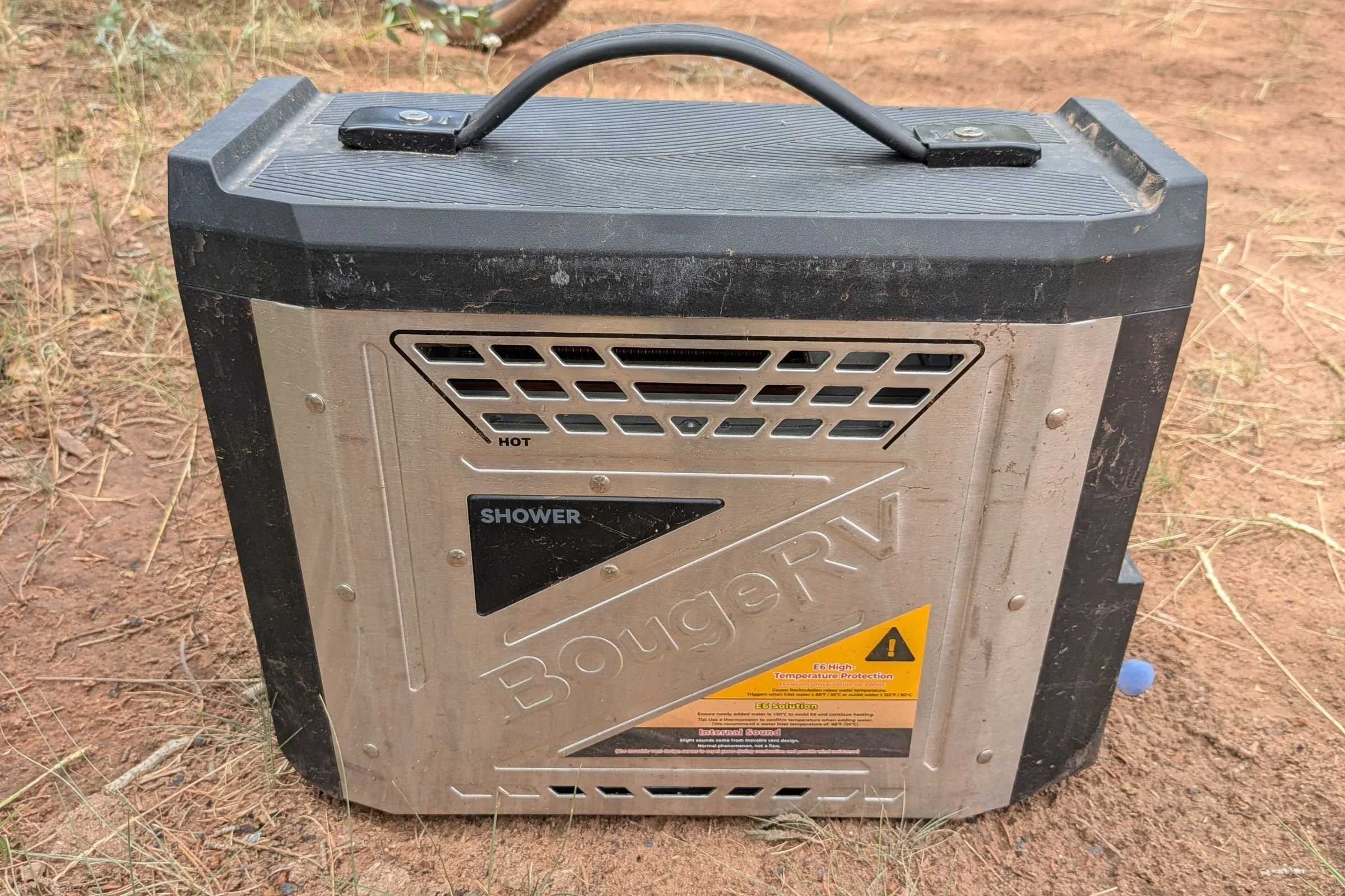 BougeRV Portable Propane Outdoor Water Heater placed on dirt in an outdoor setting.